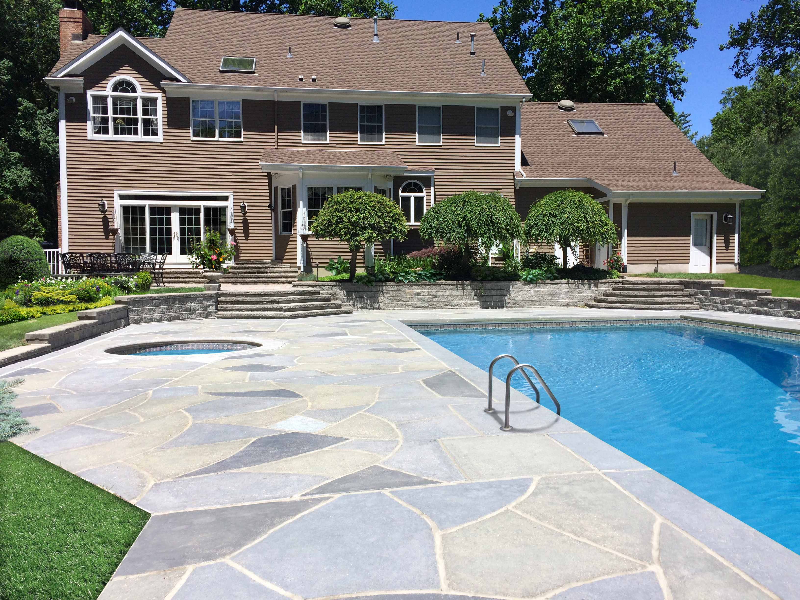Resurfaced concrete pool deck in Granite Slate finish showing modern gray stone appearance.