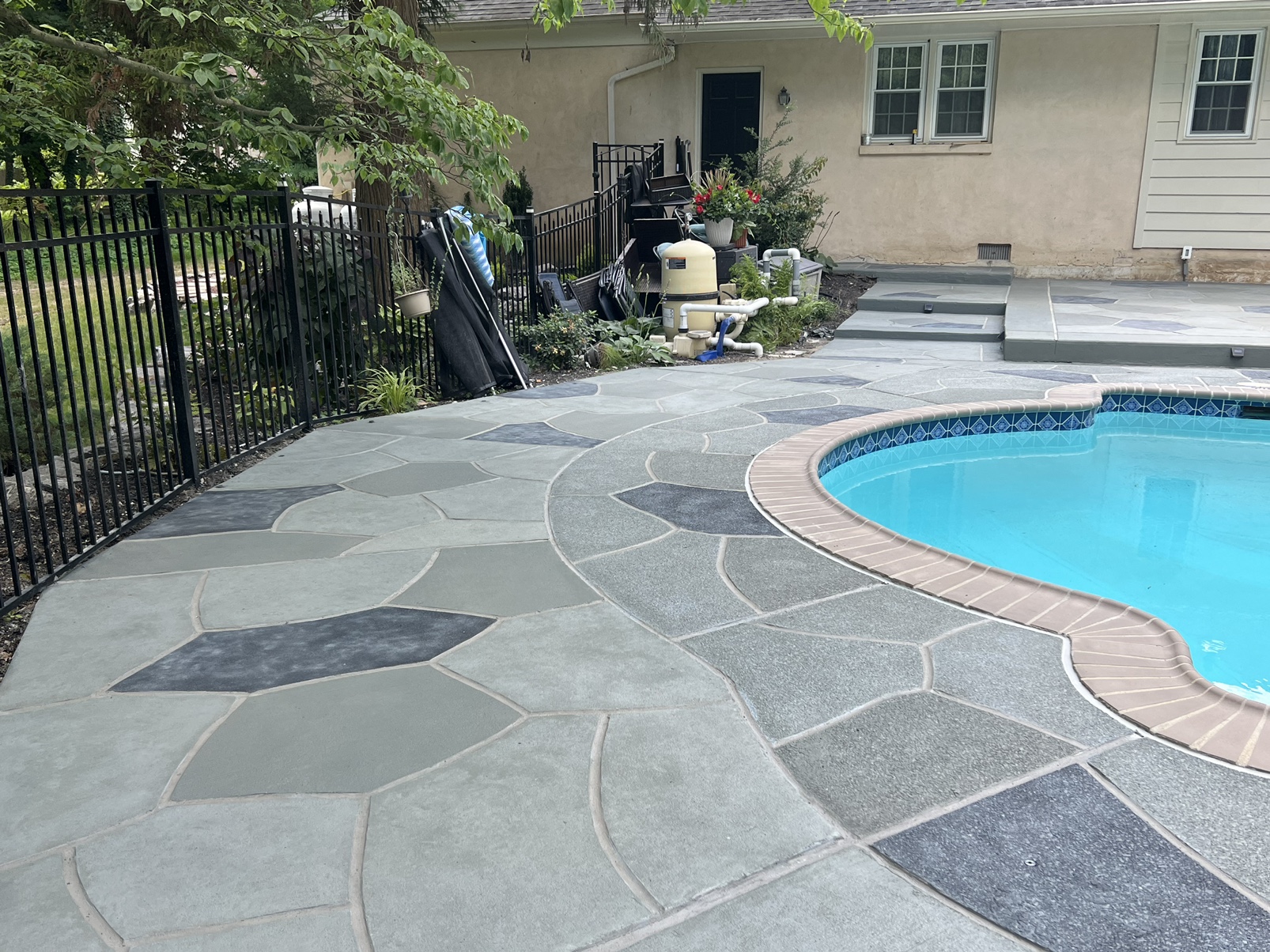 Upgraded concrete pool deck in Granite Slate finish in Princeton, NJ with clean gray slate look.