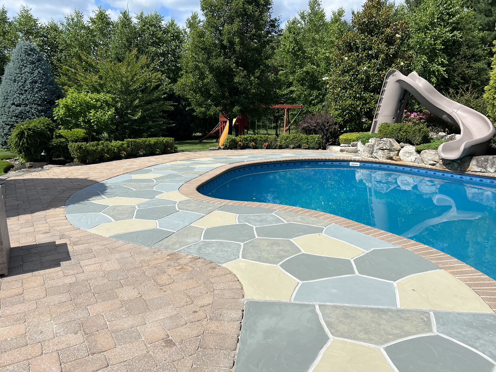 Resurfaced concrete pool deck in Granite Slate finish in Allentown, PA showing modern gray stone appearance.