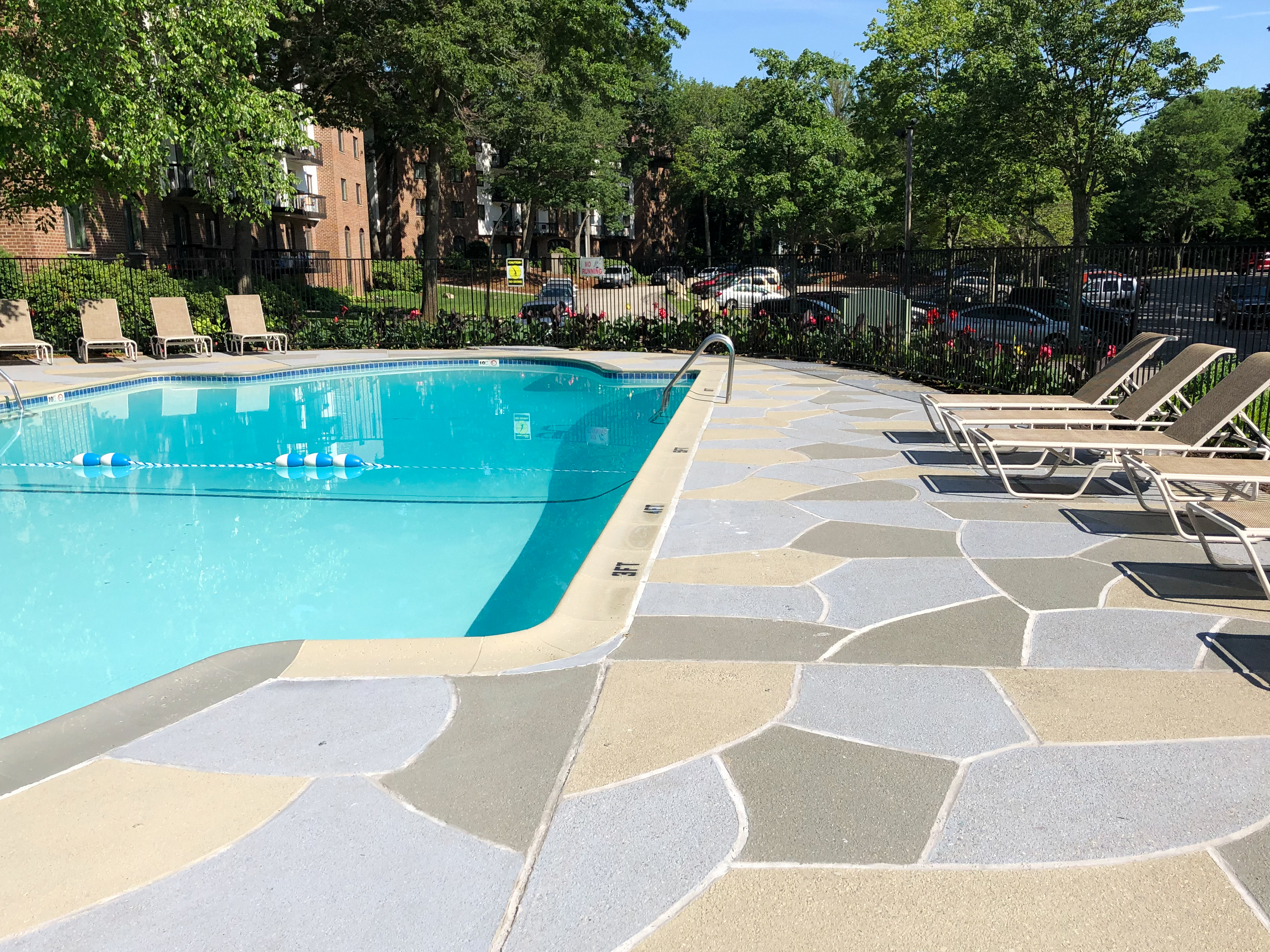Resurfaced concrete pool deck in Granite Slate finish showing modern gray stone appearance.