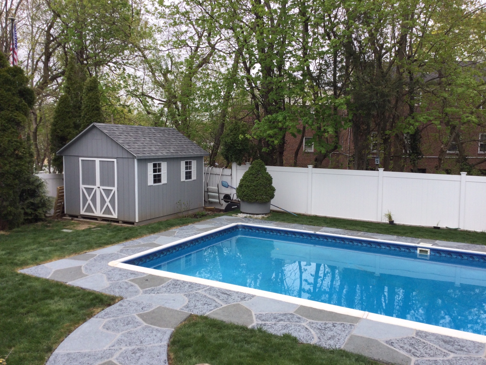 Upgraded concrete pool deck in Granite Slate finish in Plymouth, MA with clean gray slate look.