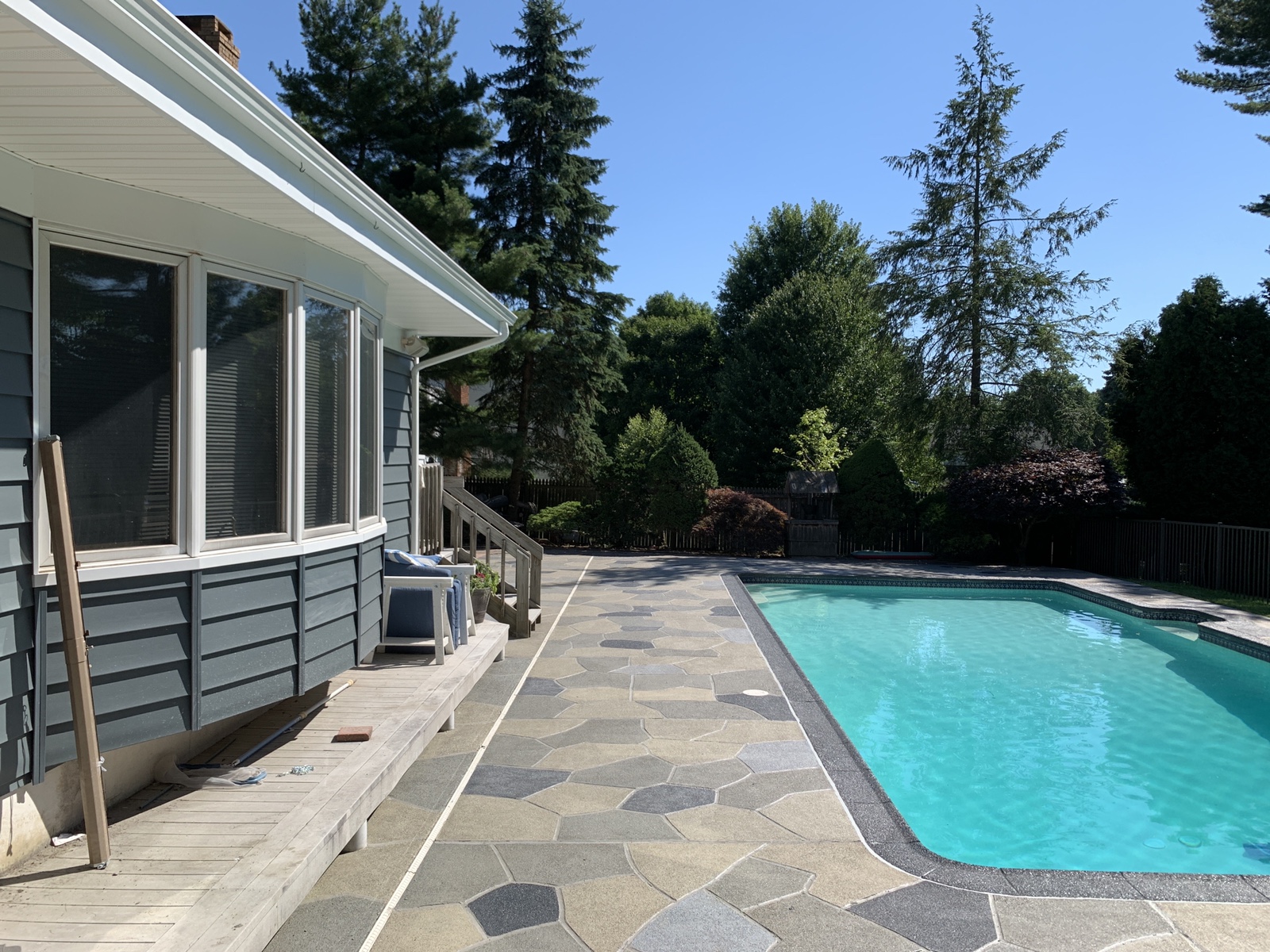 Residential pool deck in Granite Slate color theme after concrete resurfacing.