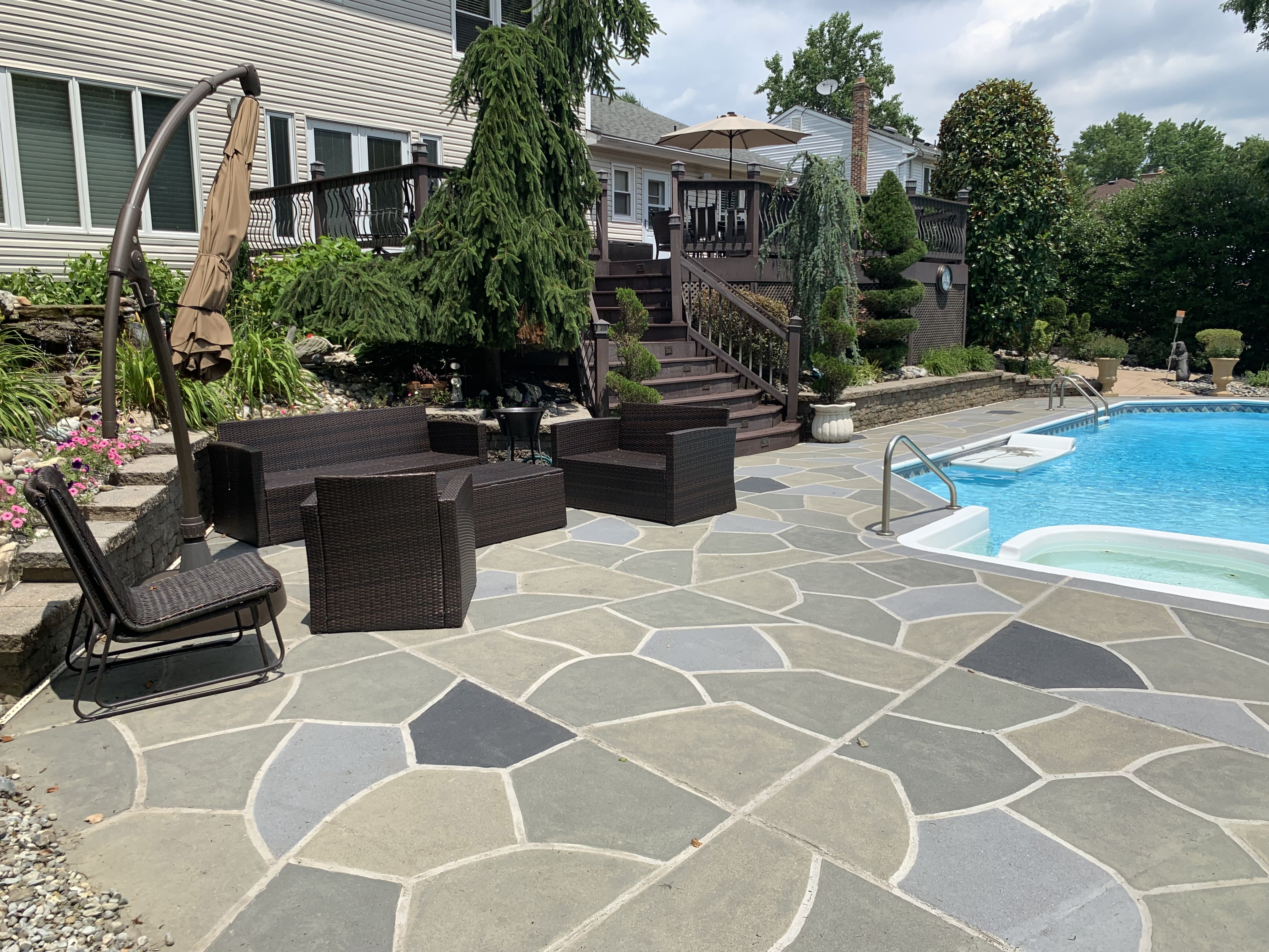Residential pool deck in Granite Slate color theme after concrete resurfacing.