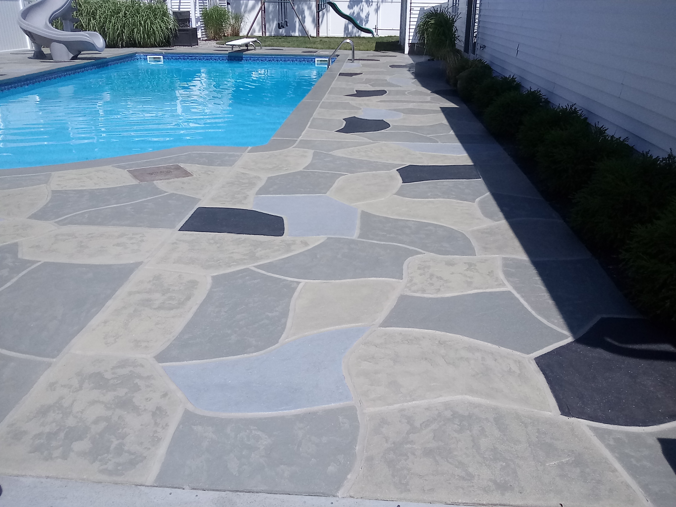 Residential pool deck in Granite Slate color theme in Annapolis, MD after concrete resurfacing.
