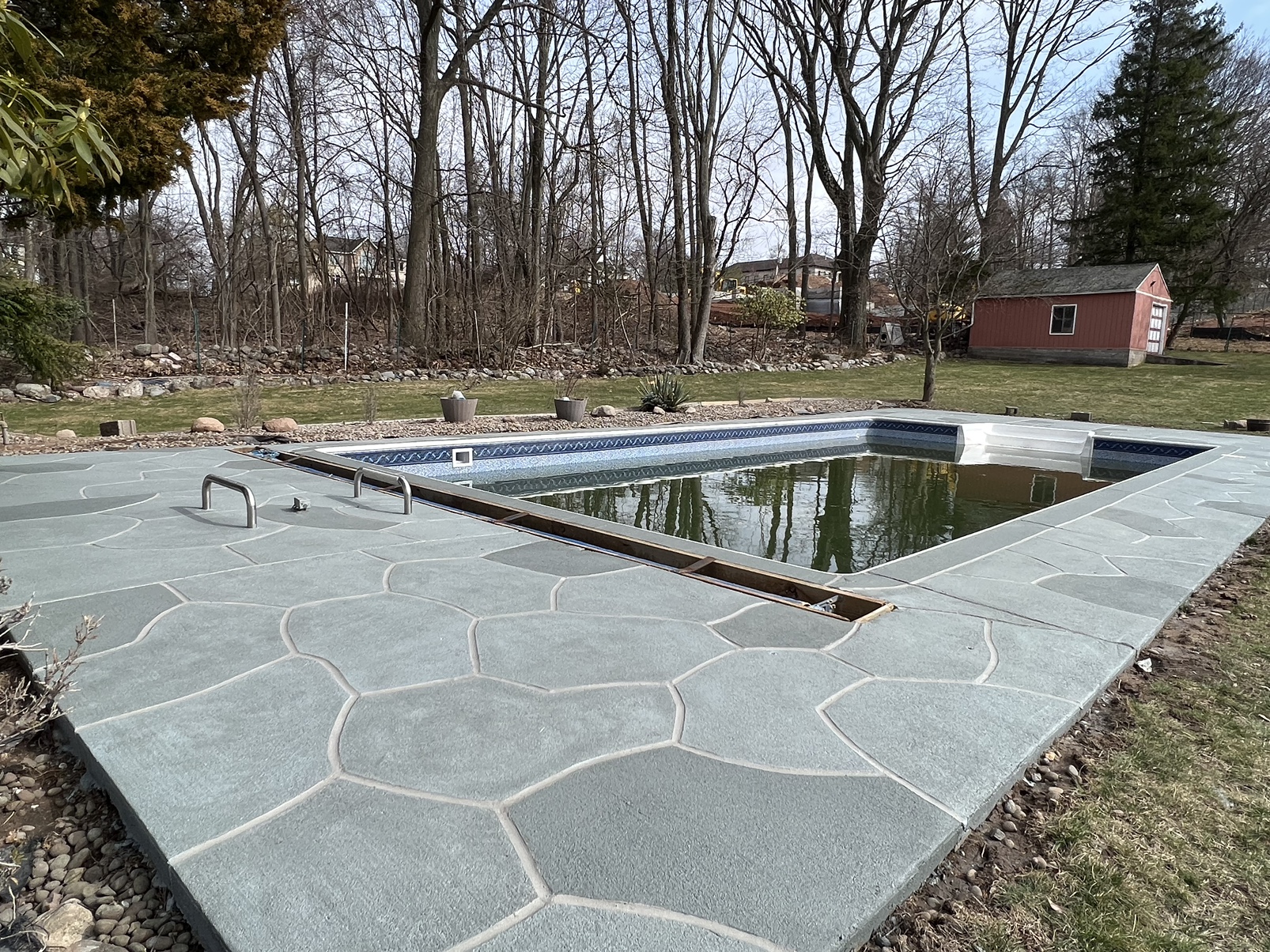 Upgraded concrete pool deck in Granite Slate finish with clean gray slate look.