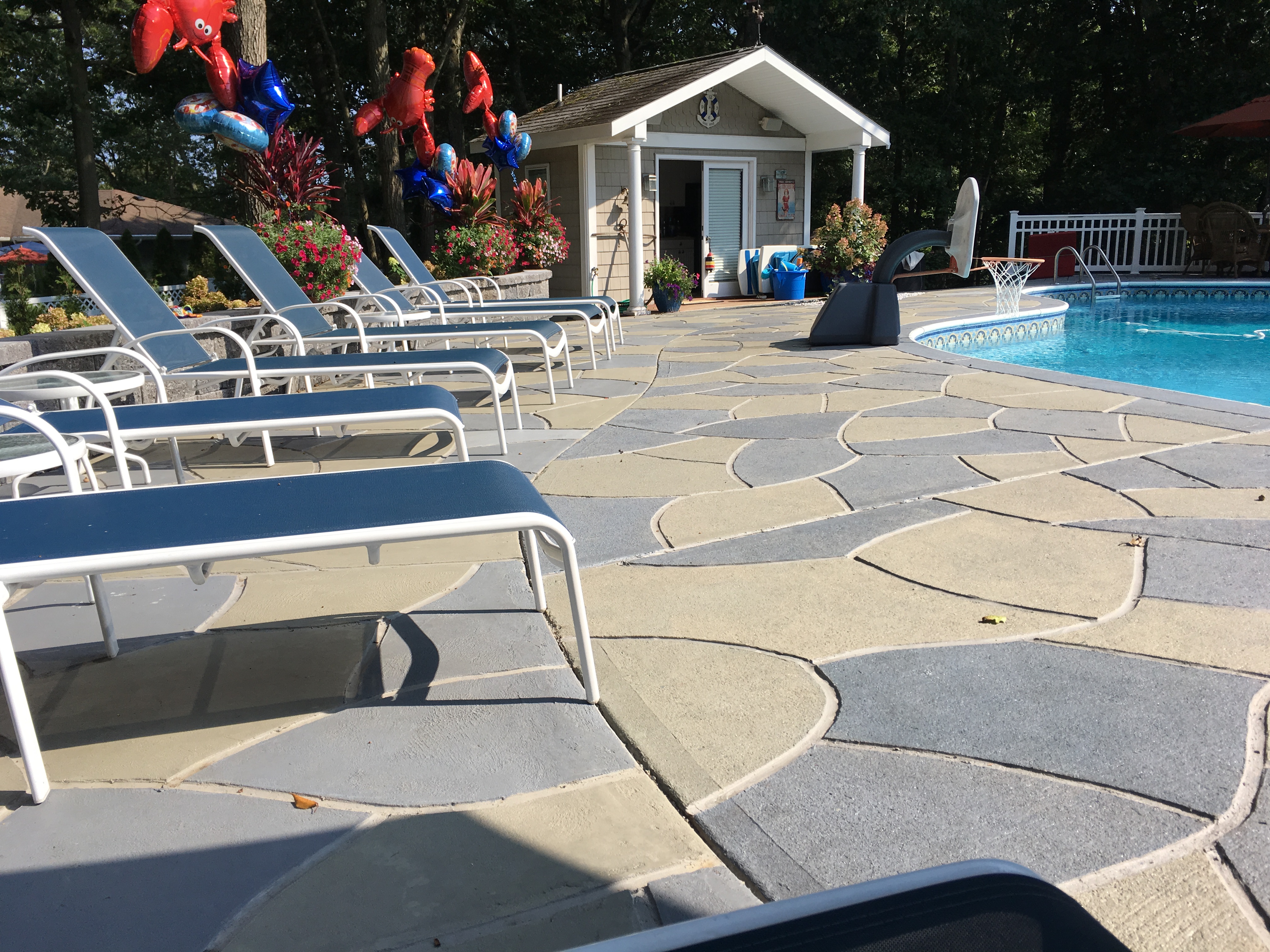 Resurfaced concrete pool deck in Granite Slate finish showing modern gray stone appearance.