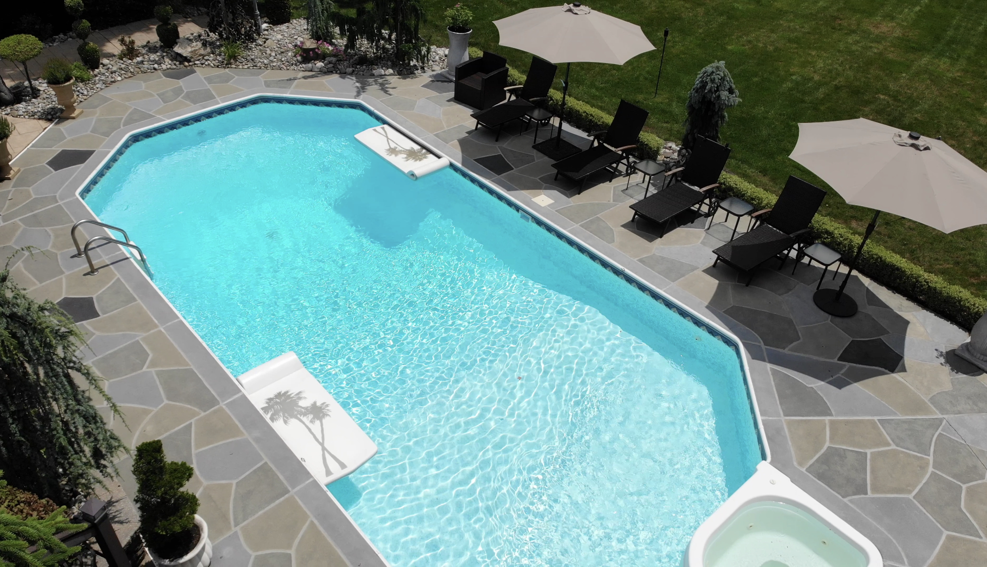 Upgraded concrete pool deck in Granite Slate finish with clean gray slate look.