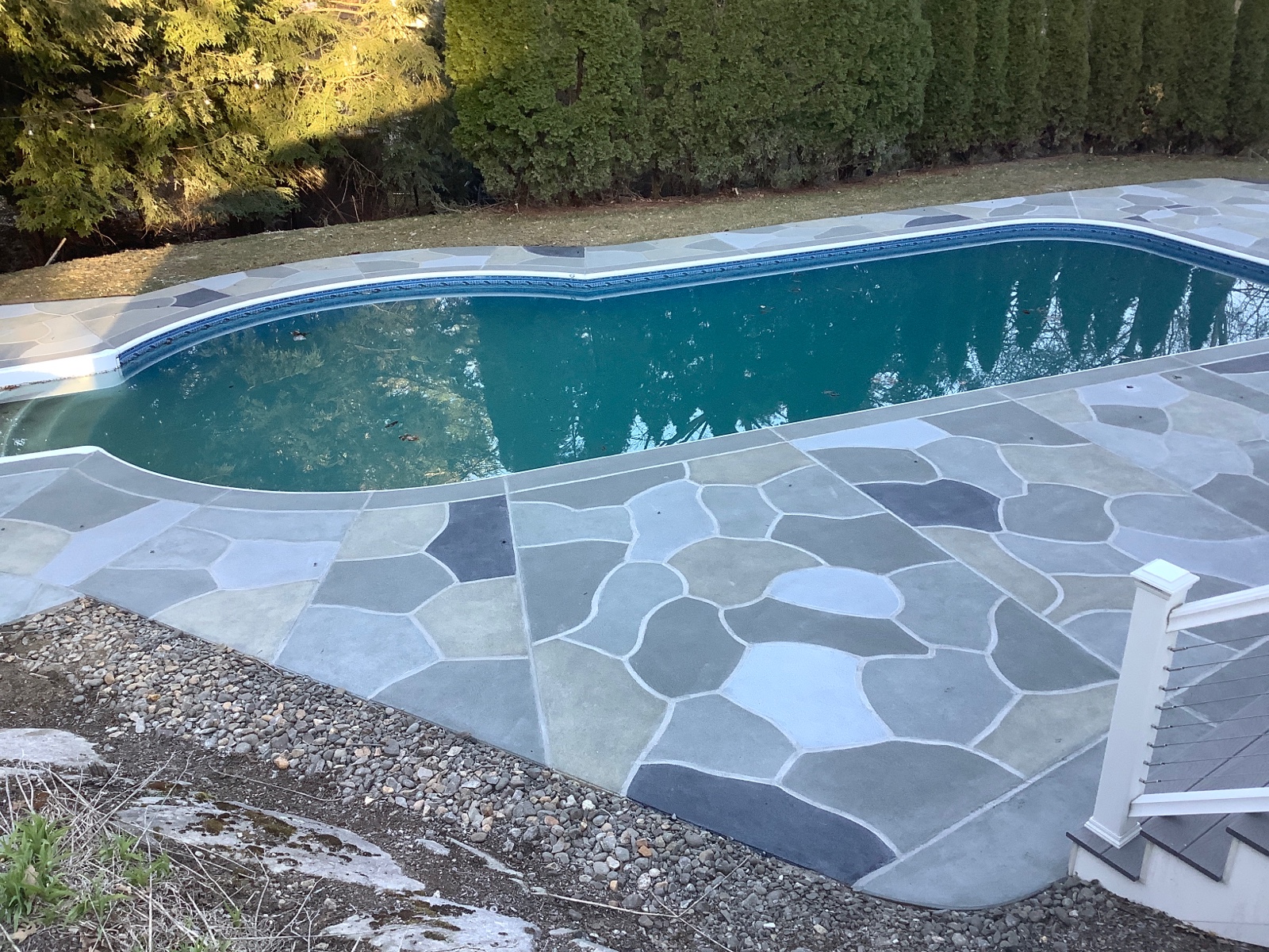 Residential pool deck in Granite Slate color theme after concrete resurfacing.