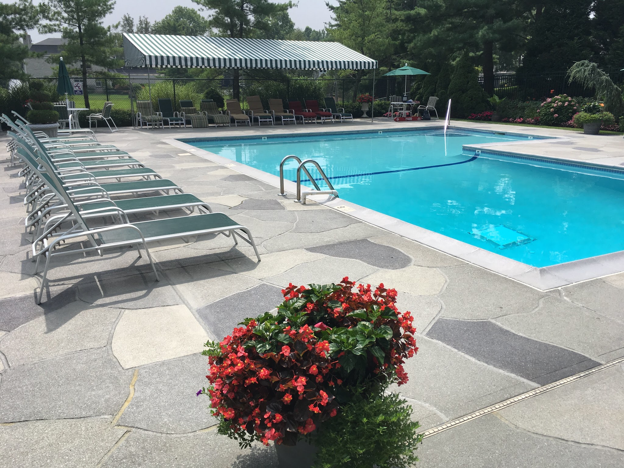 Upgraded concrete pool deck in Granite Slate finish with clean gray slate look.