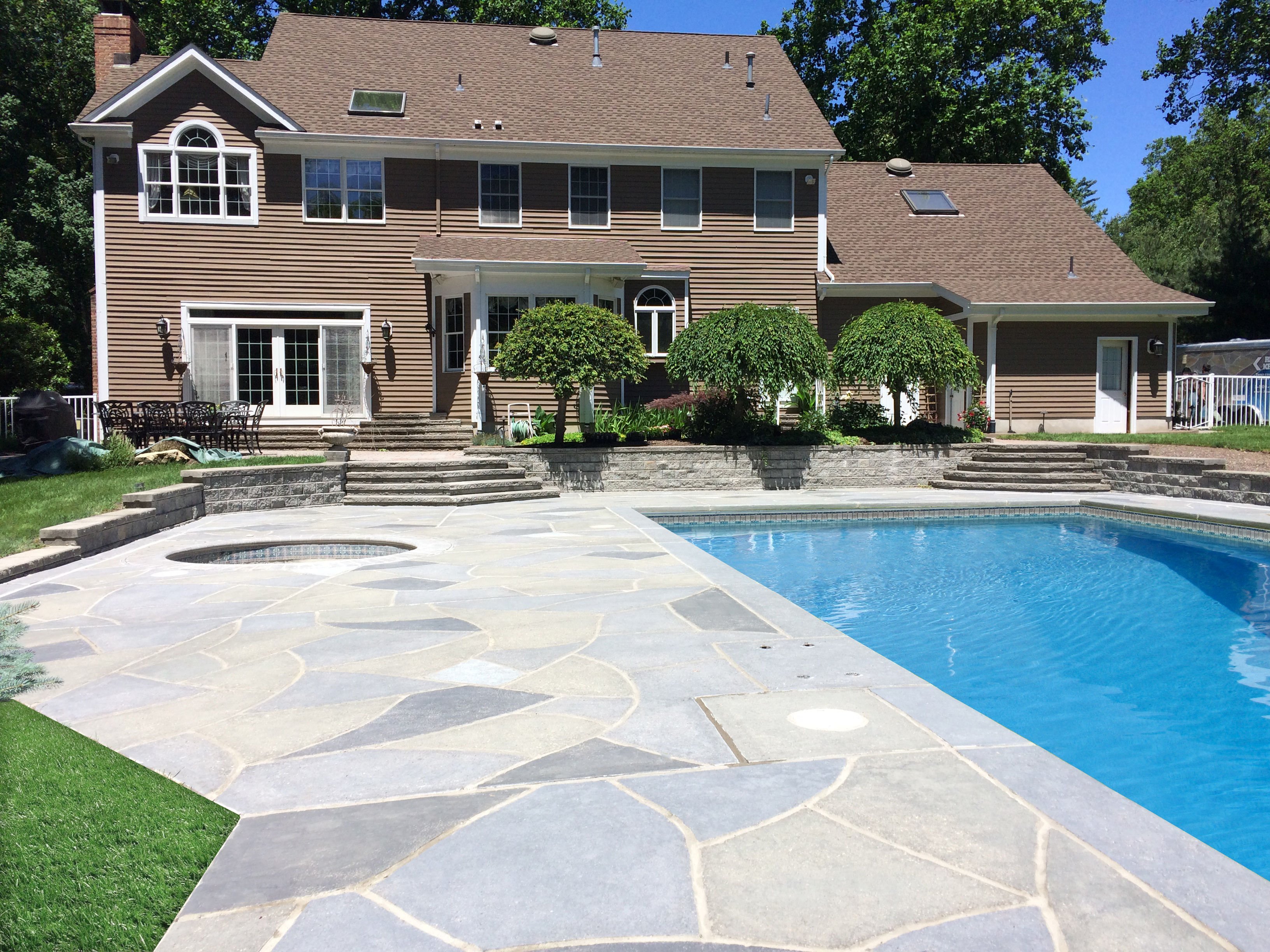Residential pool deck in Granite Slate color theme after concrete resurfacing.