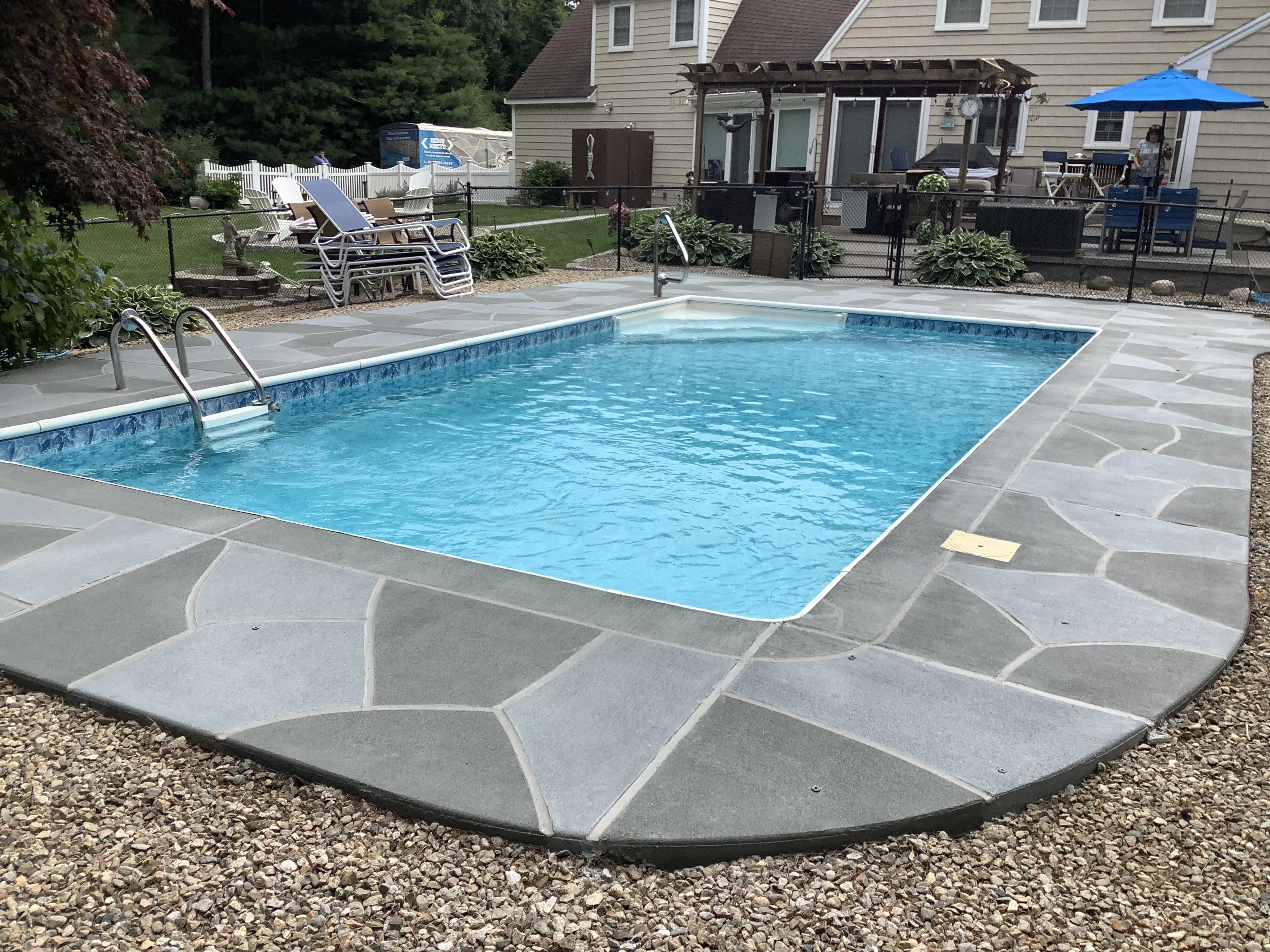 Residential pool deck in Granite Slate color theme in Stamford, CT after concrete resurfacing.