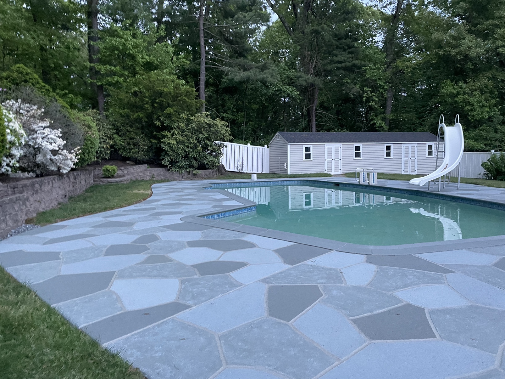 Upgraded concrete pool deck in Granite Slate finish with clean gray slate look.