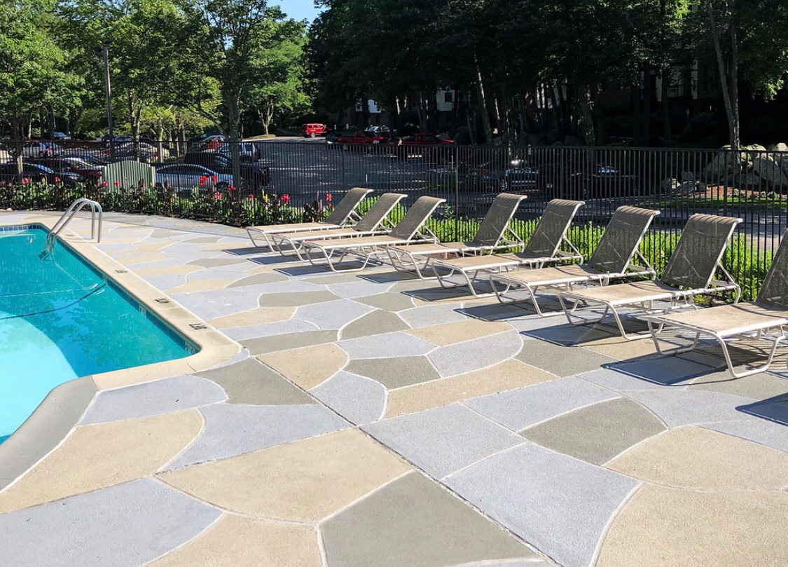 Upgraded concrete pool deck in Granite Slate finish with clean gray slate look.