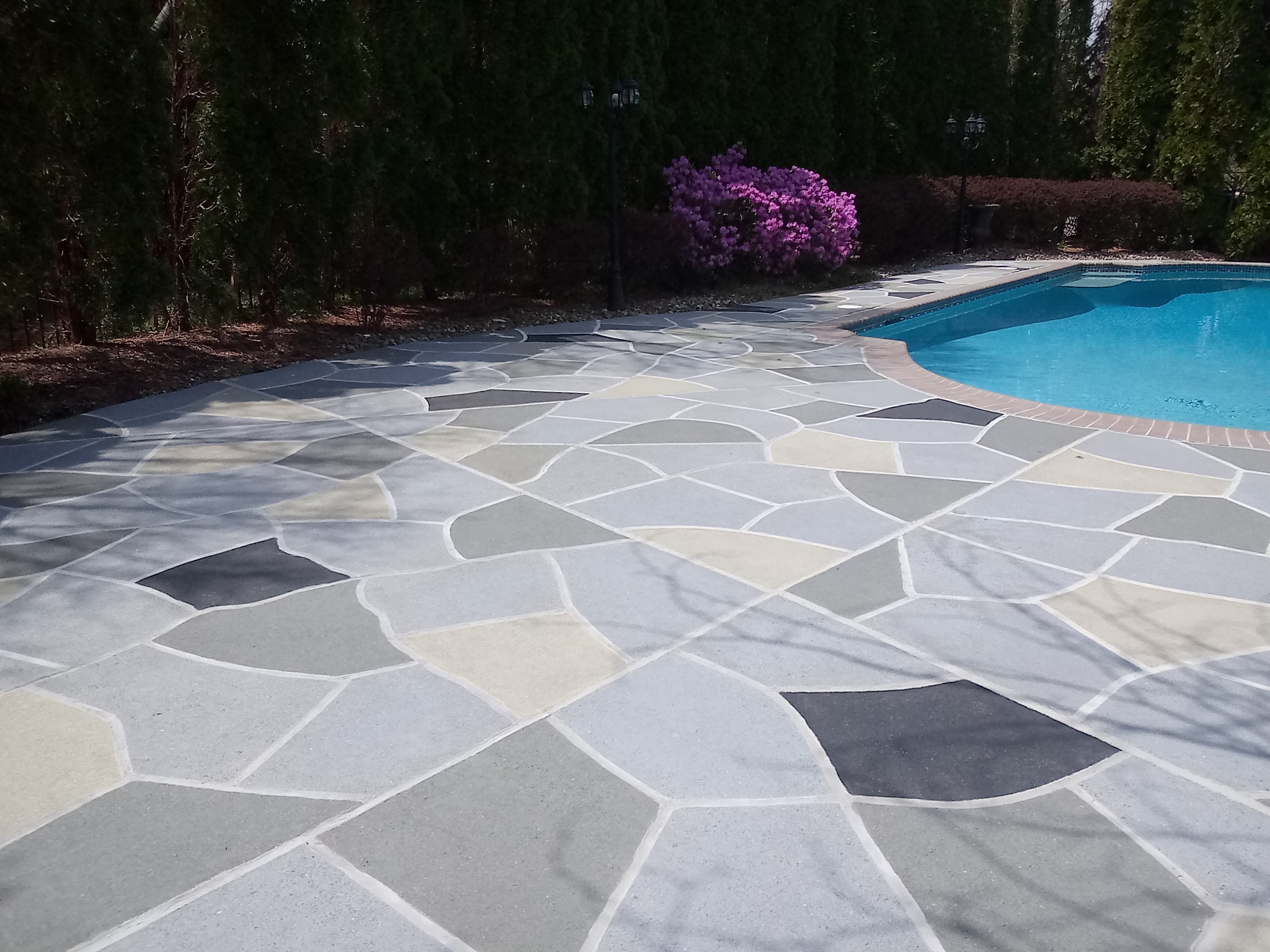 Upgraded concrete pool deck in Granite Slate finish with clean gray slate look.