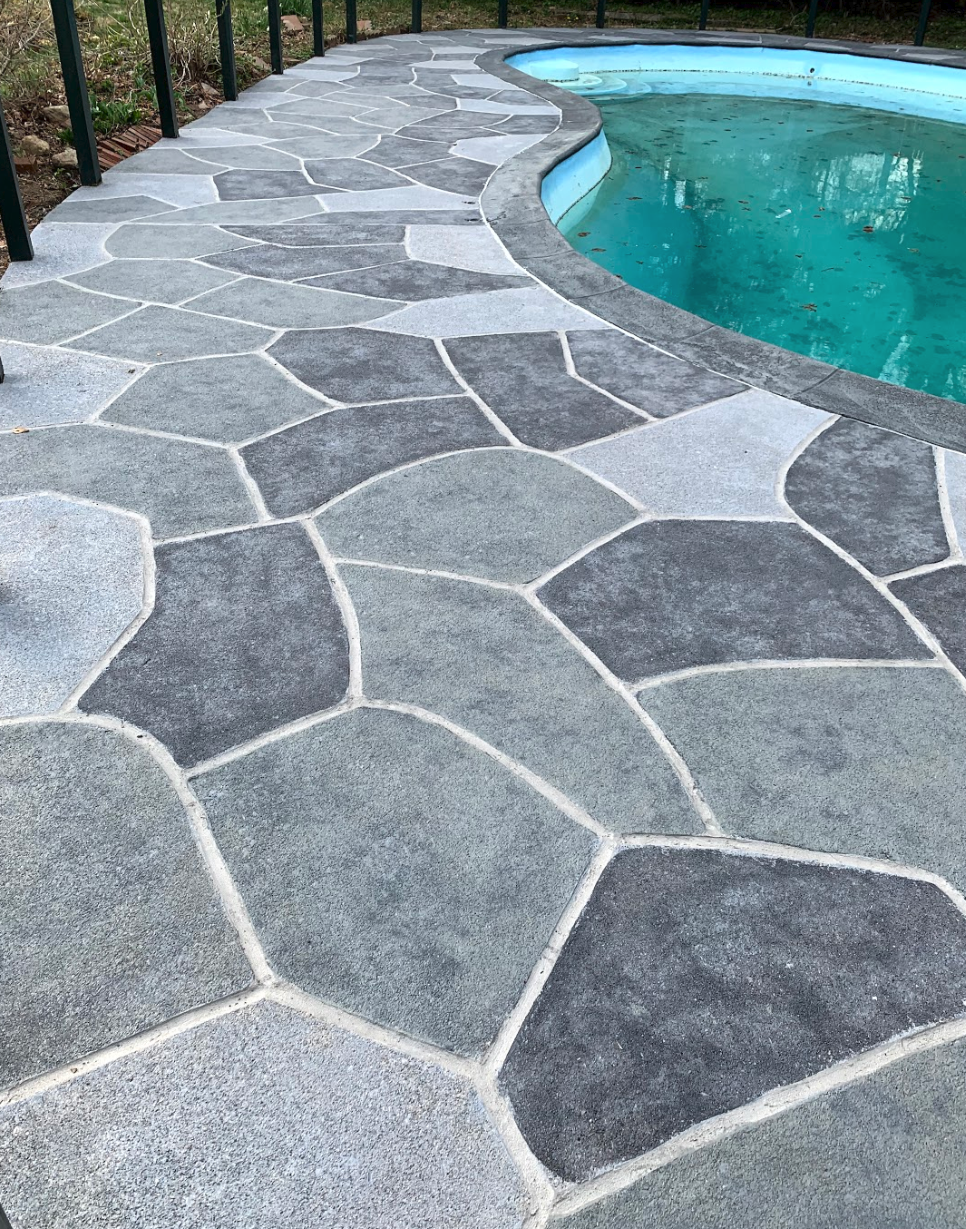 Residential pool deck in Granite Slate color theme after concrete resurfacing.