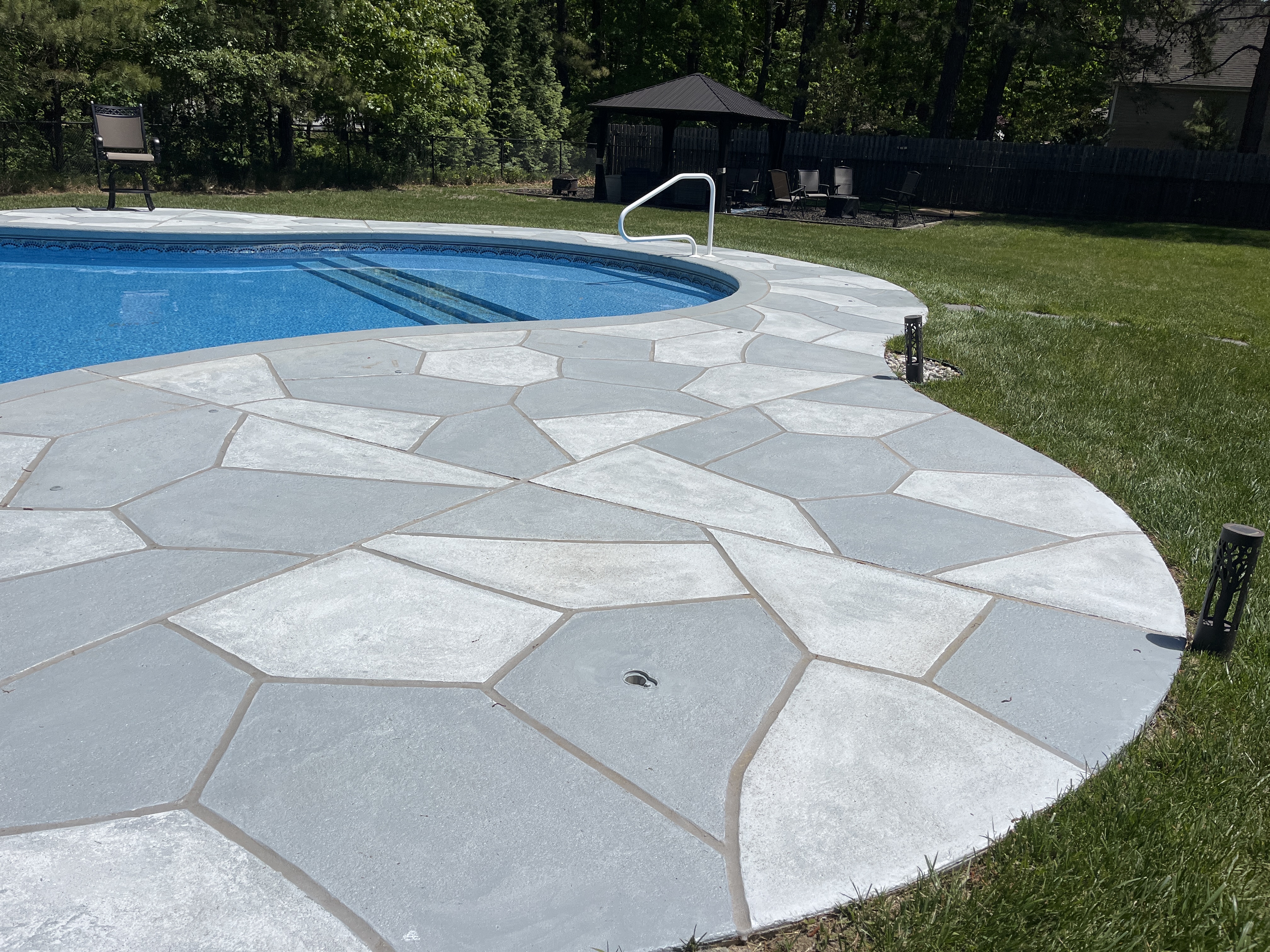 Residential pool deck in Granite Slate color theme after concrete resurfacing.