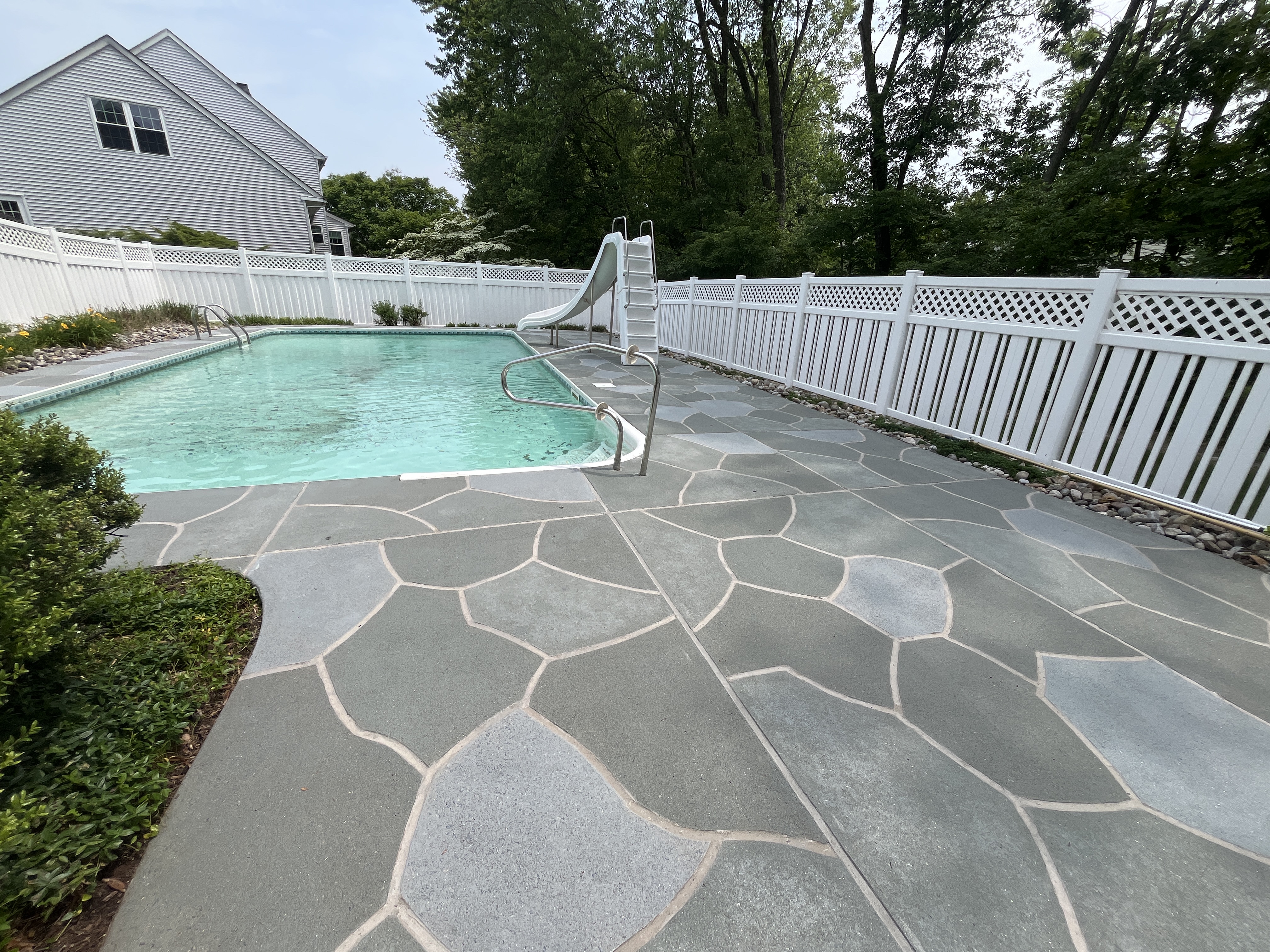 Granite Slate pool deck concrete resurfacing project with refined slate like texture.