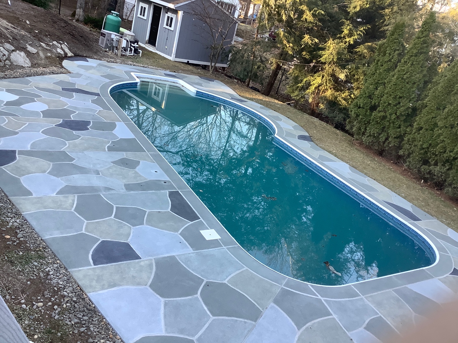 Resurfaced concrete pool deck in Granite Slate finish showing modern gray stone appearance.