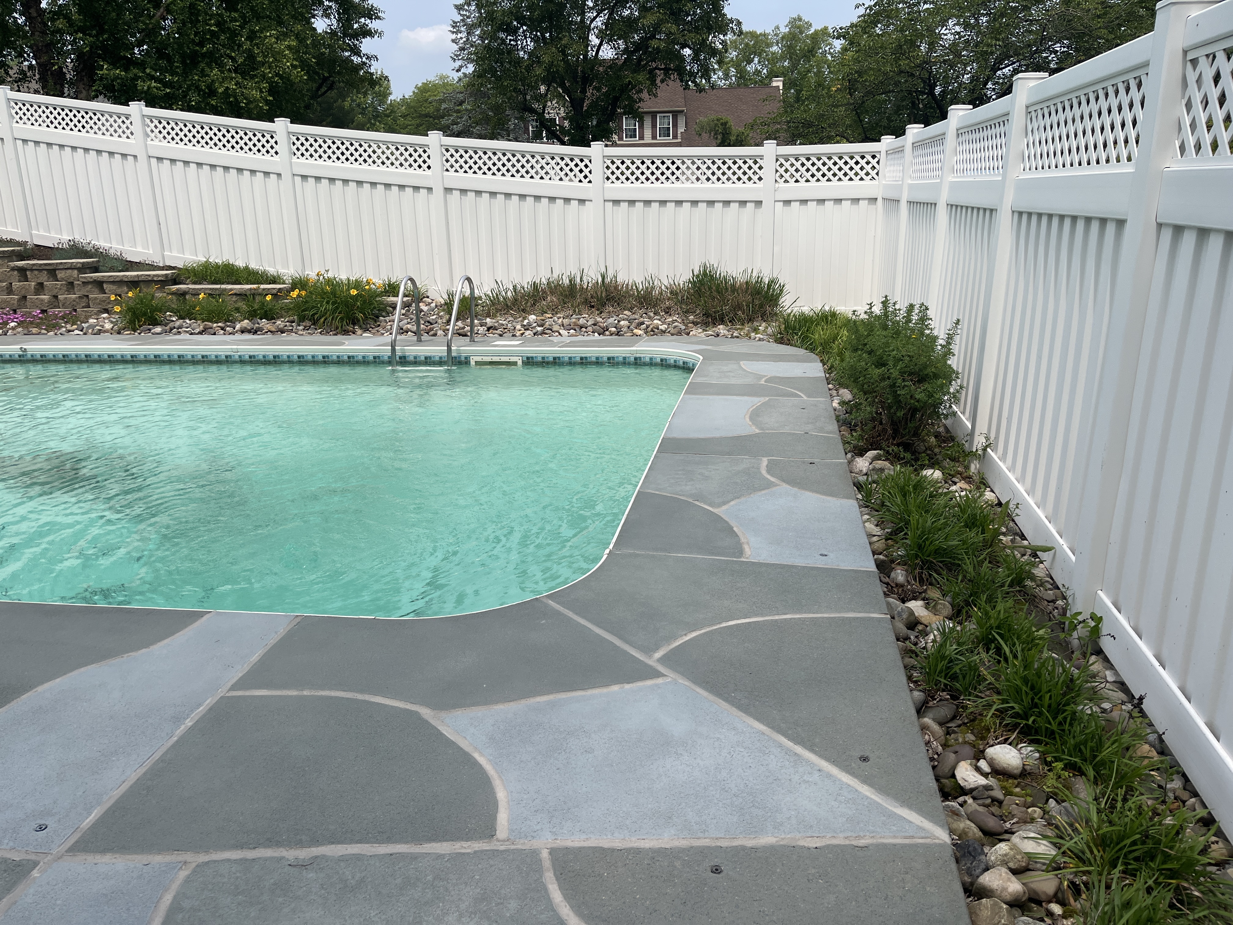 Upgraded concrete pool deck in Granite Slate finish with clean gray slate look.