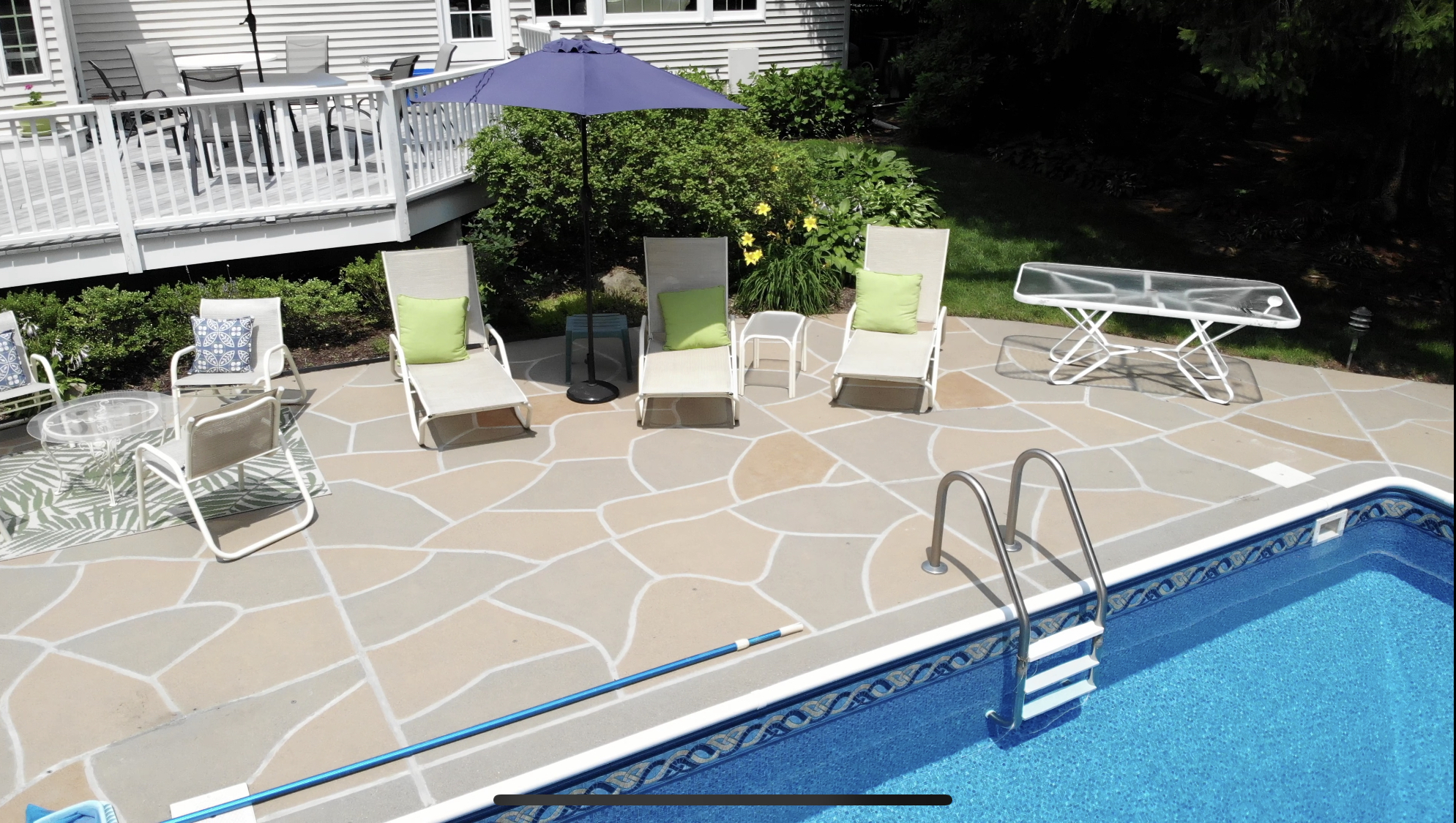 RenuKrete resurfaced pool deck in Hurricane Slate showing modern slate-like aesthetic in Newton, MA