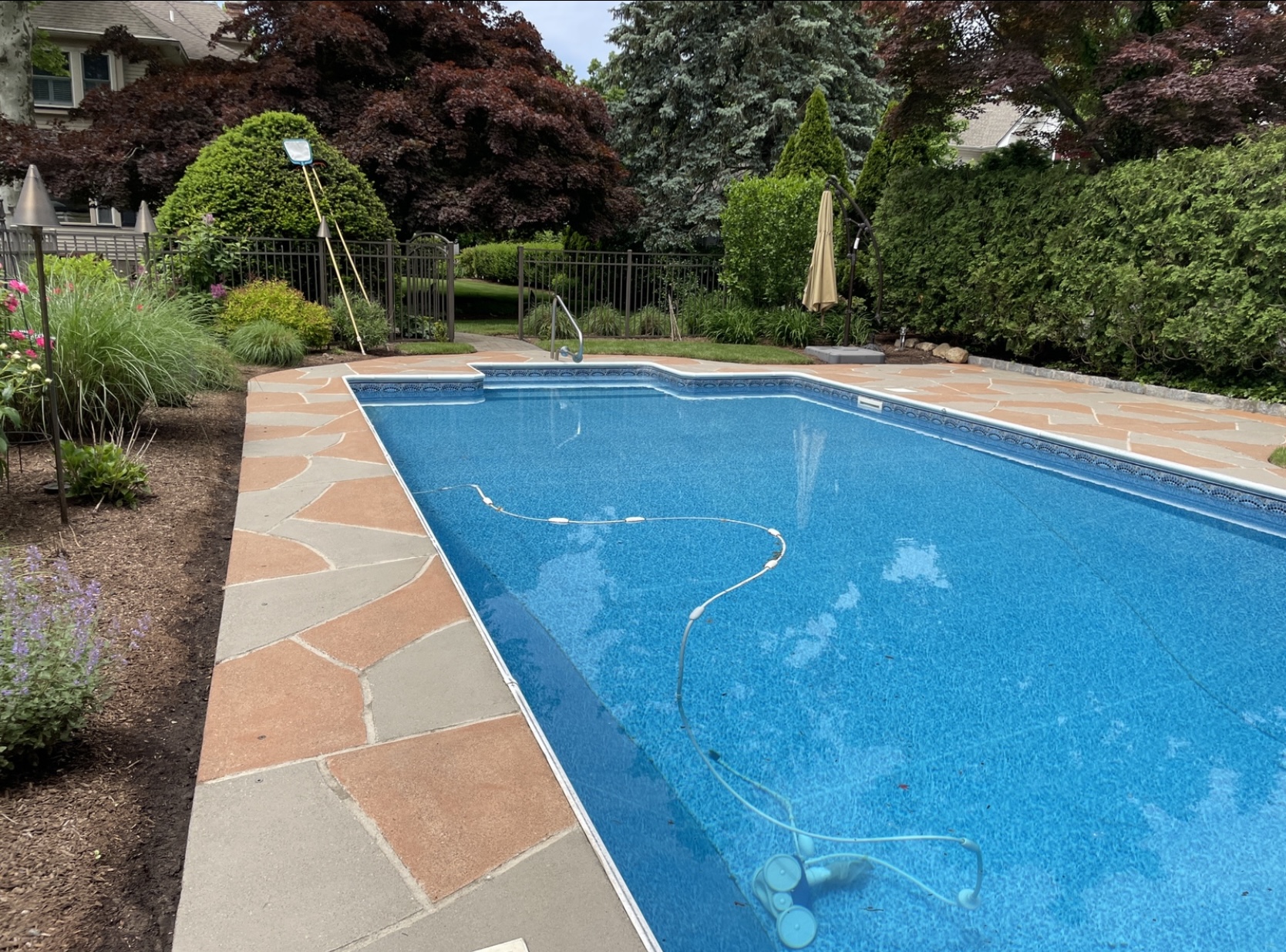 RenuKrete resurfaced pool deck in Hurricane Slate showing weathered slate appearance