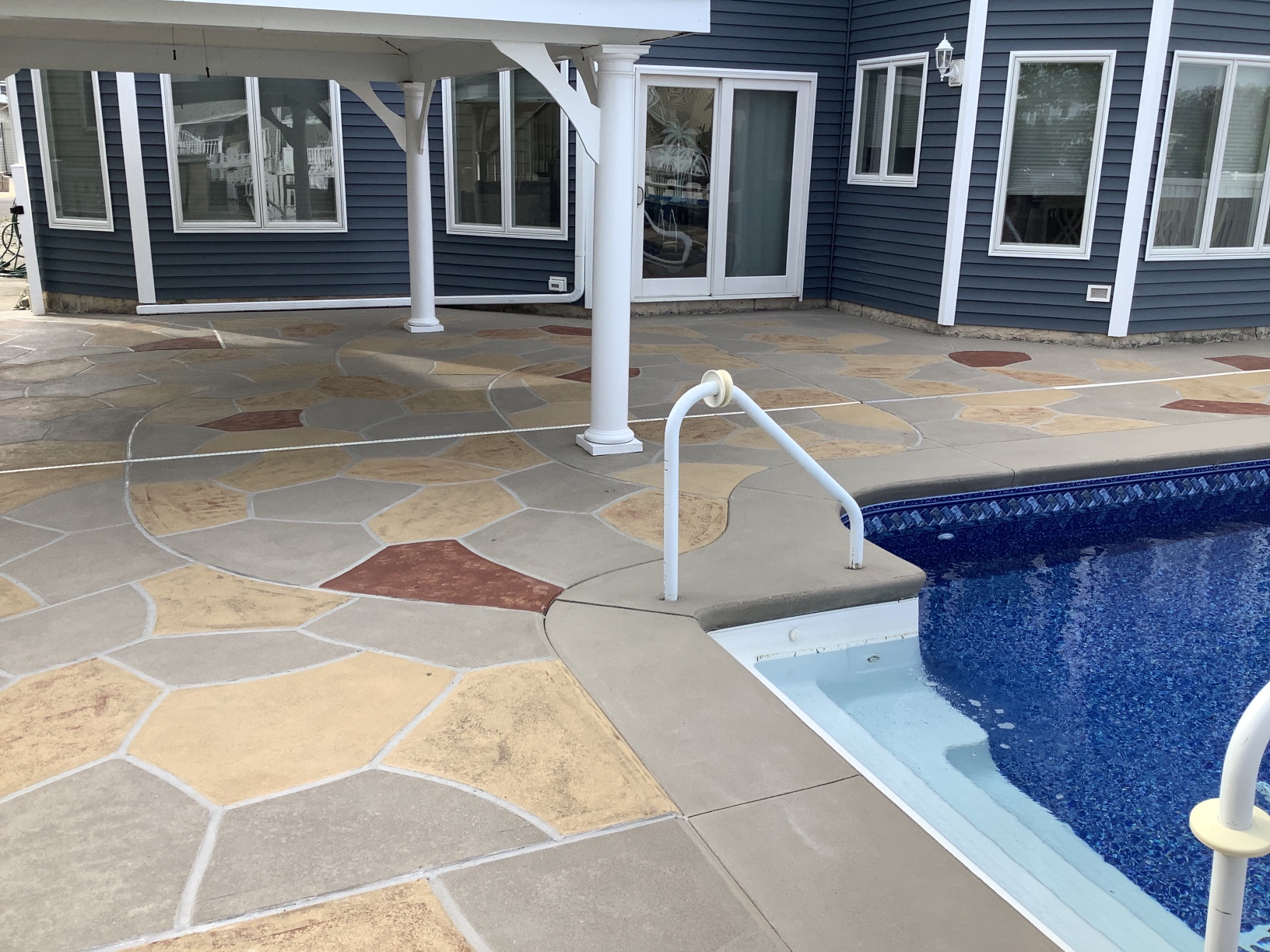 RenuKrete resurfaced pool deck in Hurricane Slate showing textured slate-like pattern