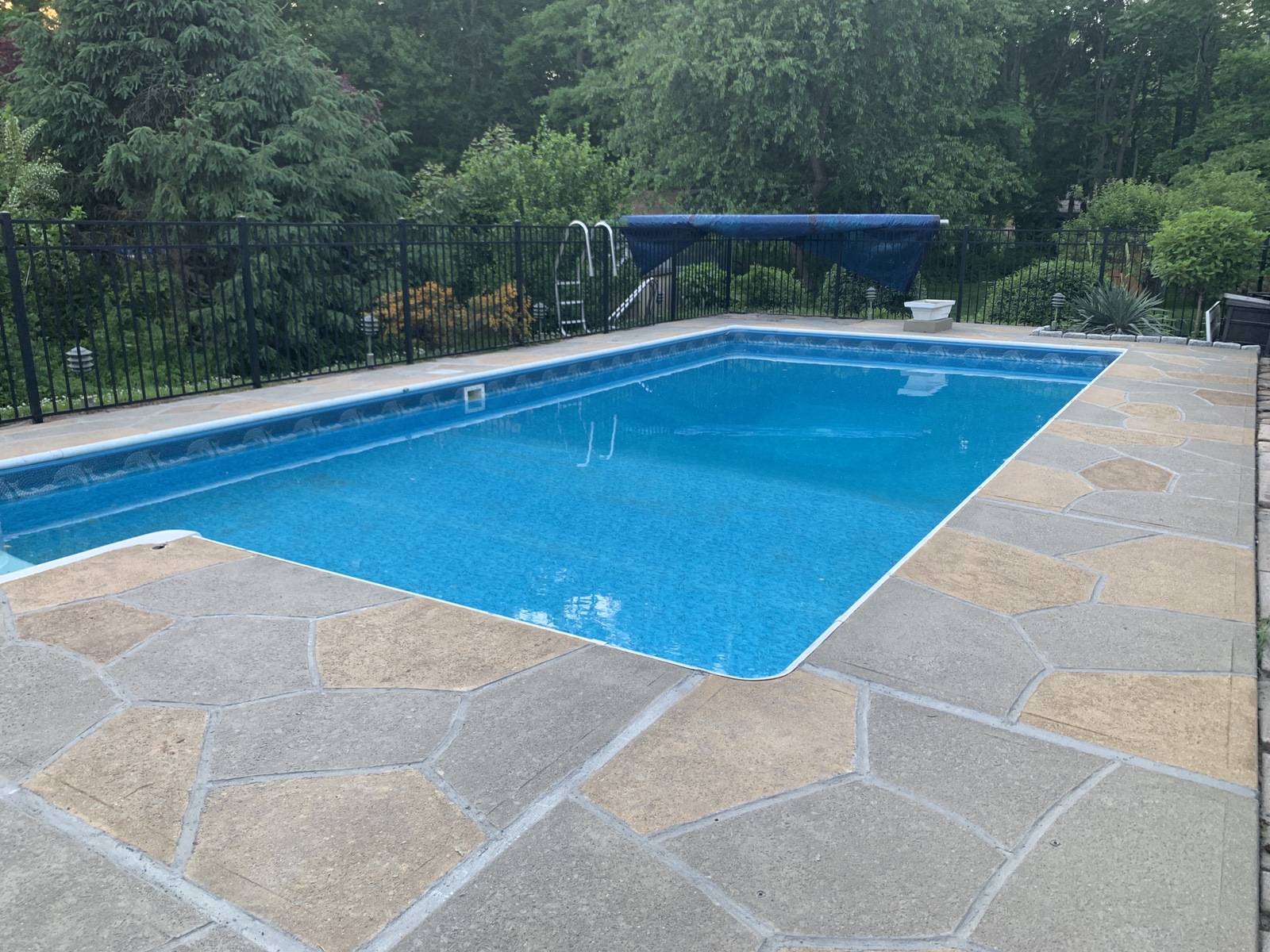 RenuKrete resurfaced pool deck in Hurricane Slate showing textured slate-like pattern
