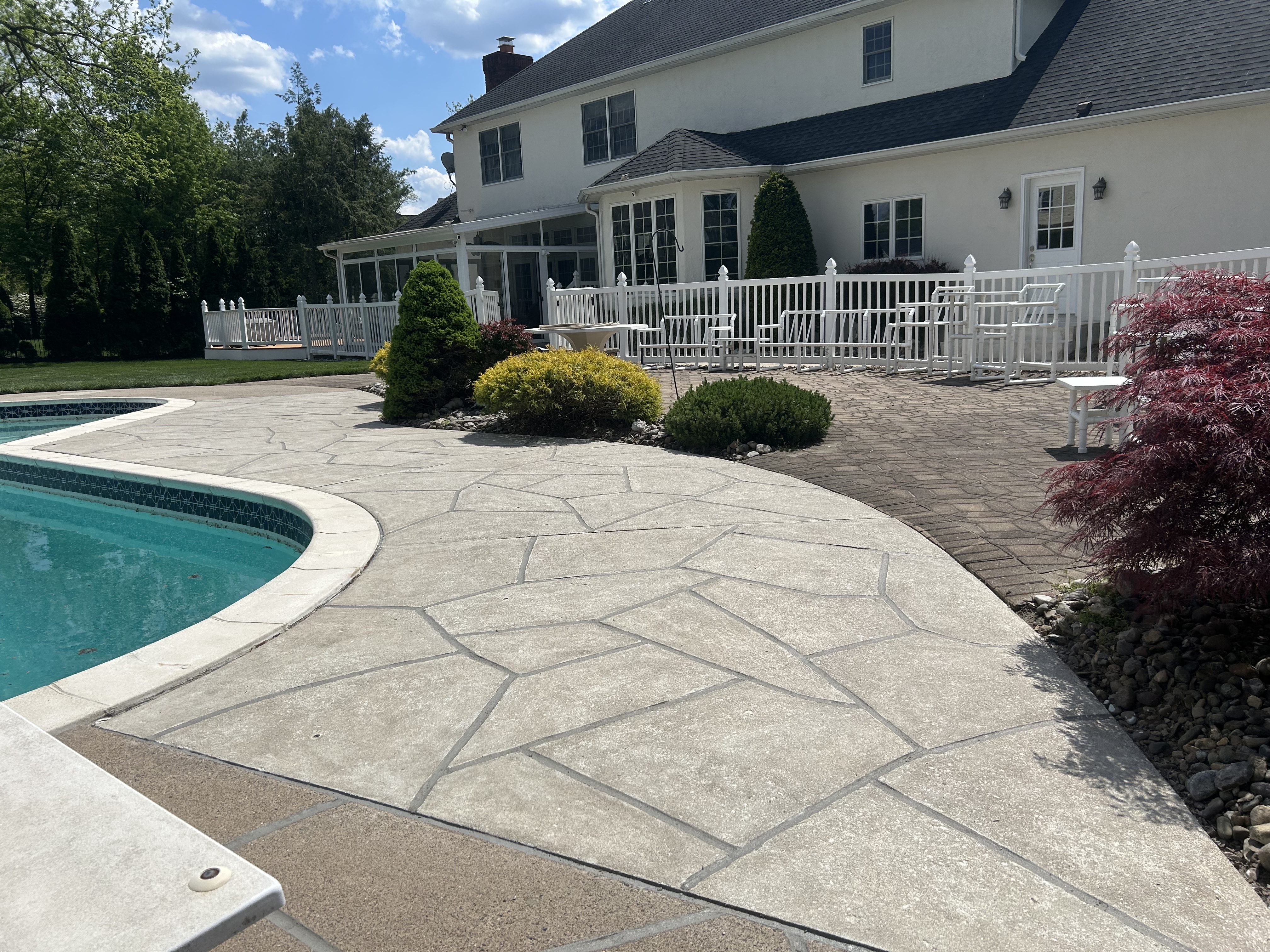 Sandstone concrete pool deck repair featuring soft stone-like texture in Stamford, CT