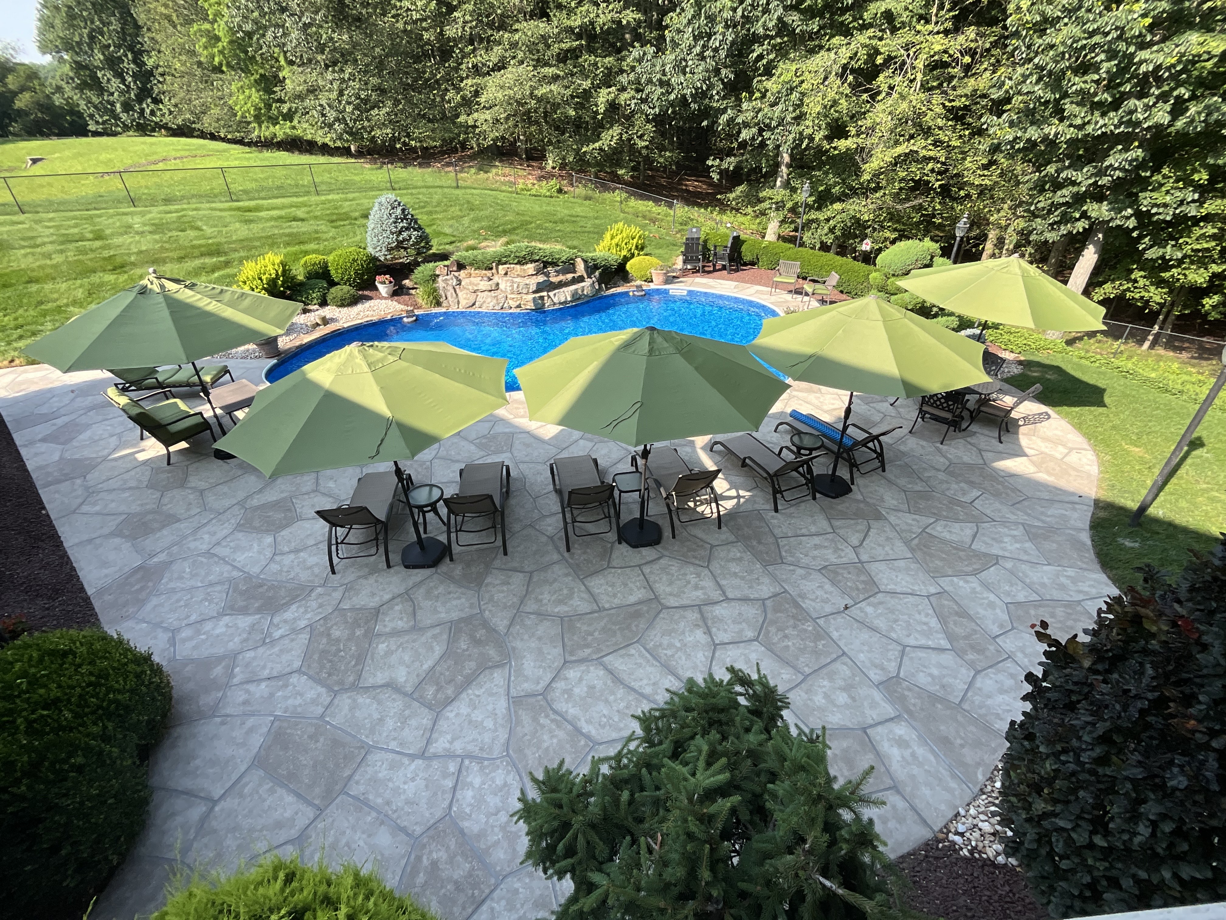RenuKrete resurfaced pool deck in Sandstone showing durable resurfaced concrete