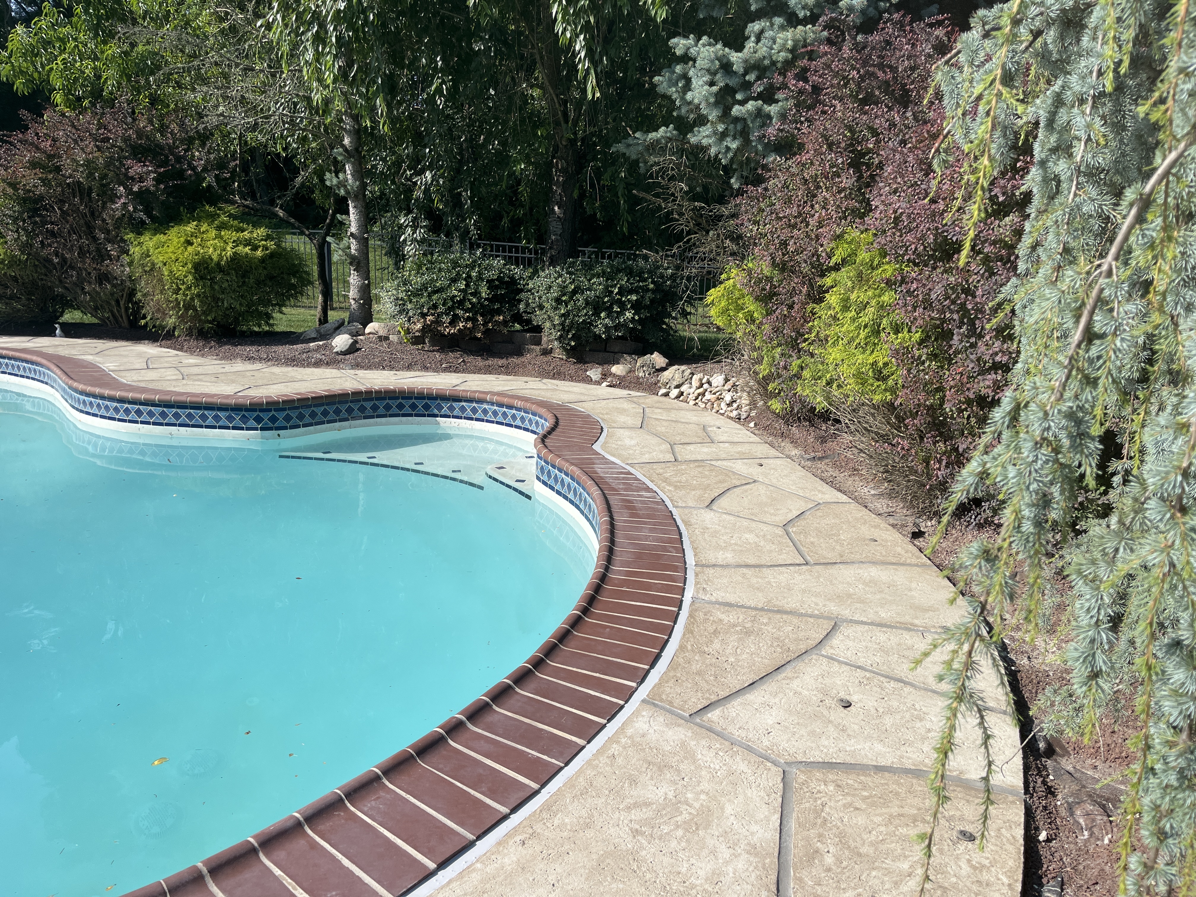 Sandstone concrete pool deck repair featuring warm earth-tone surface in Rockville, MD
