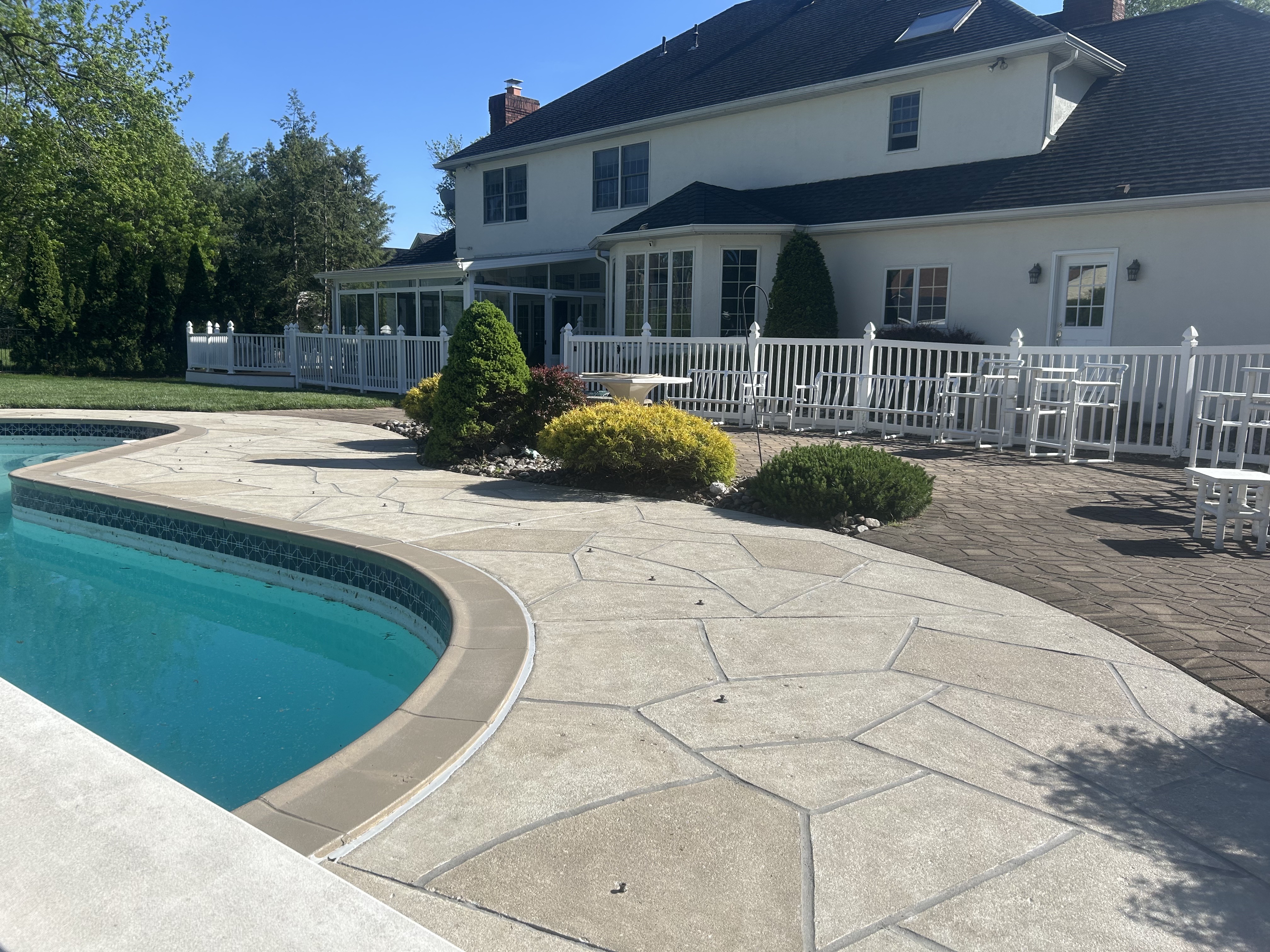 Warm-toned Sandstone pool deck renovation displaying light, warm stone aesthetic