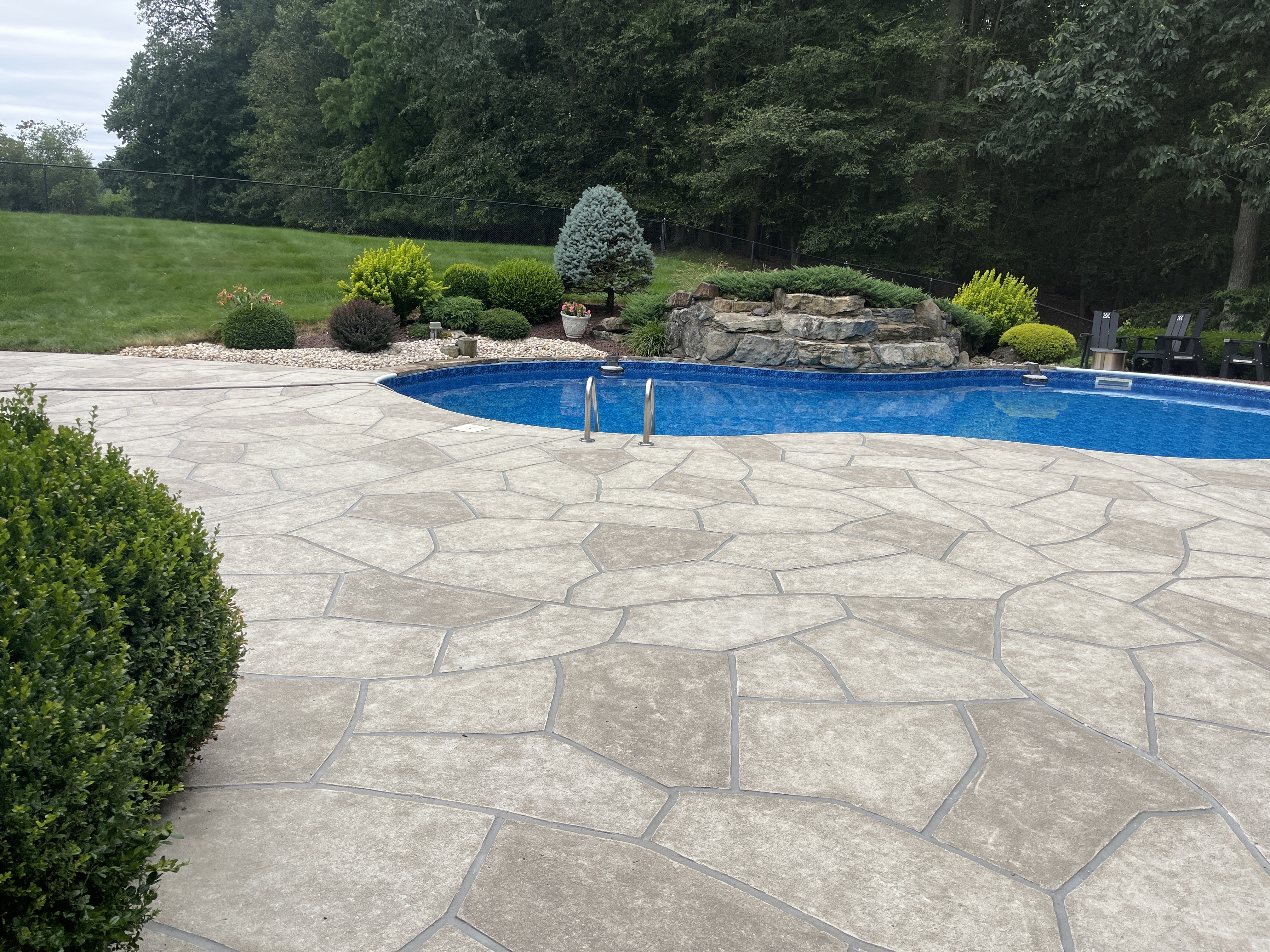 Sandstone concrete pool deck repair featuring natural sandstone appearance in Plymouth, MA