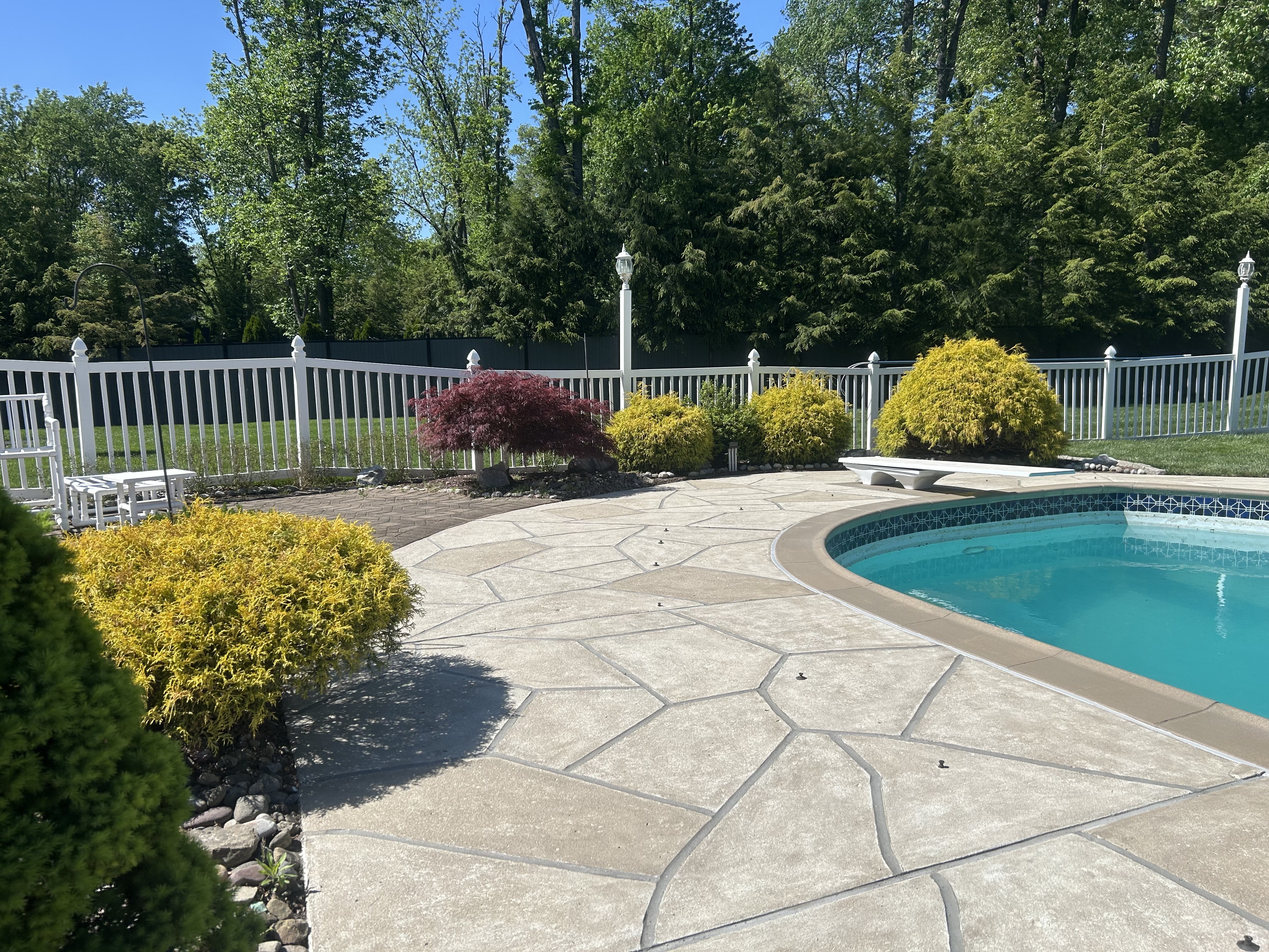 RenuKrete resurfaced pool deck in Sandstone showing soft stone-like texture in Summit, NJ