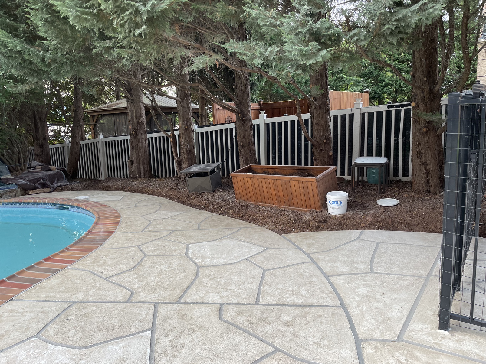 Warm-toned Sandstone pool deck renovation displaying durable resurfaced concrete