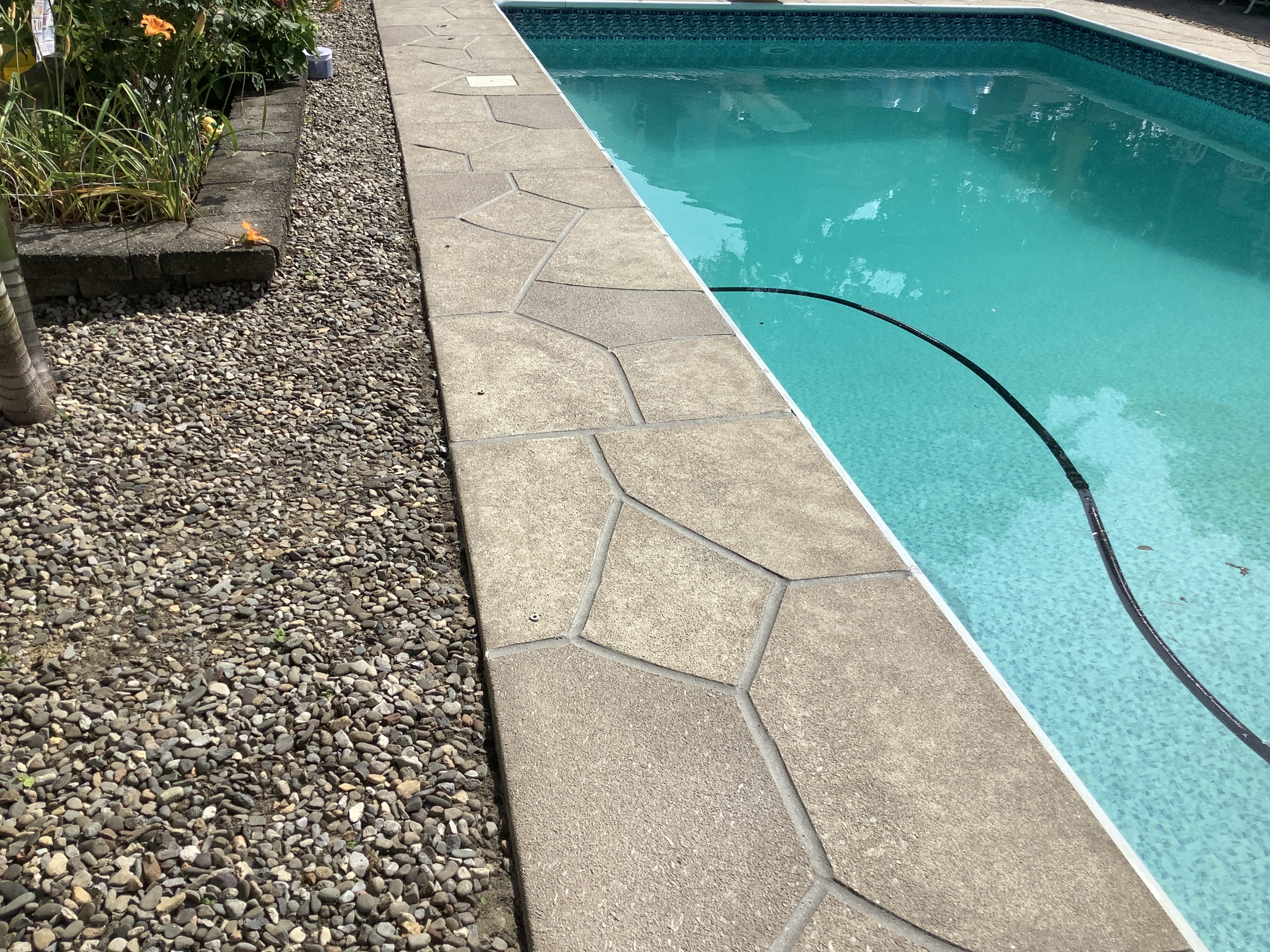 Pool deck resurfaced in Sandstone finish with light, warm stone aesthetic