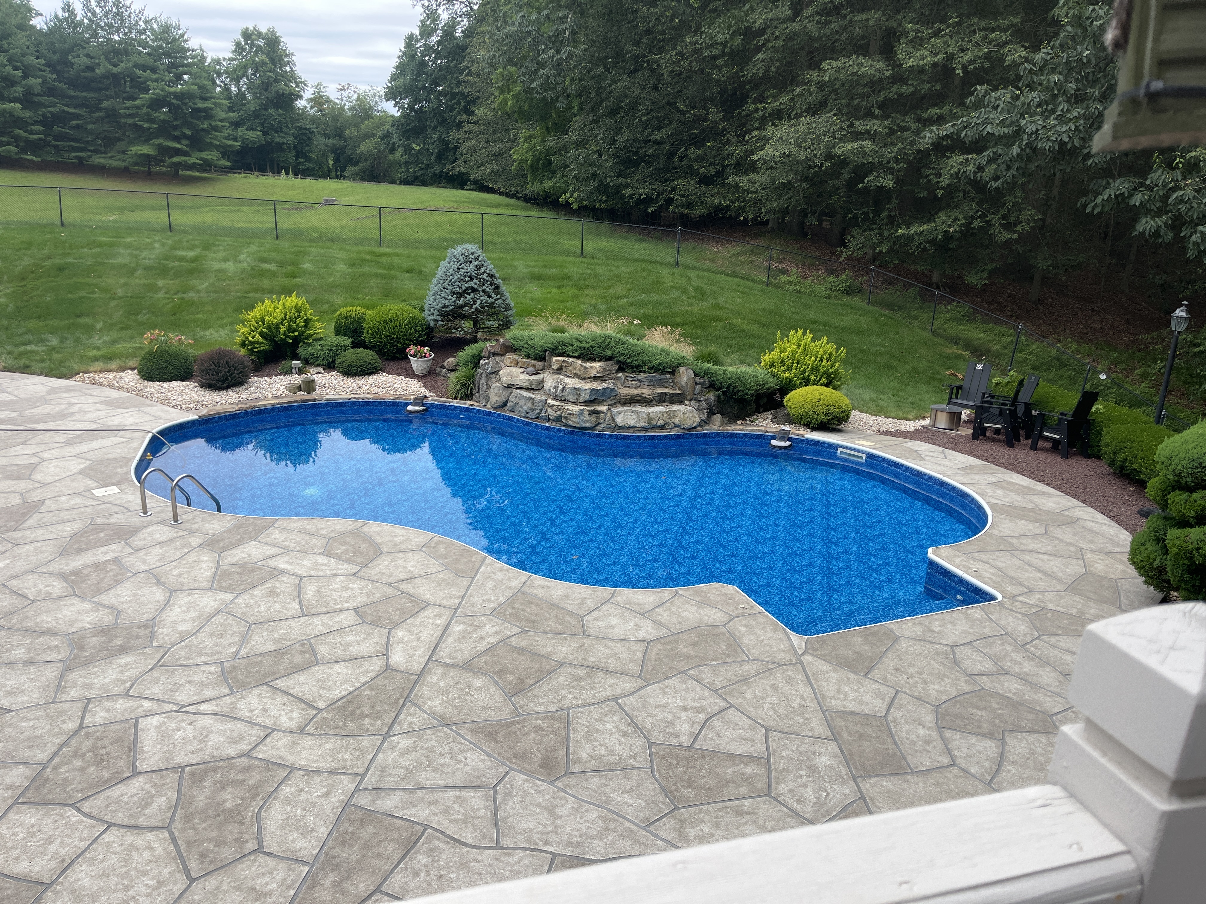 RenuKrete resurfaced pool deck in Sandstone showing warm earth-tone surface in Annapolis, MD