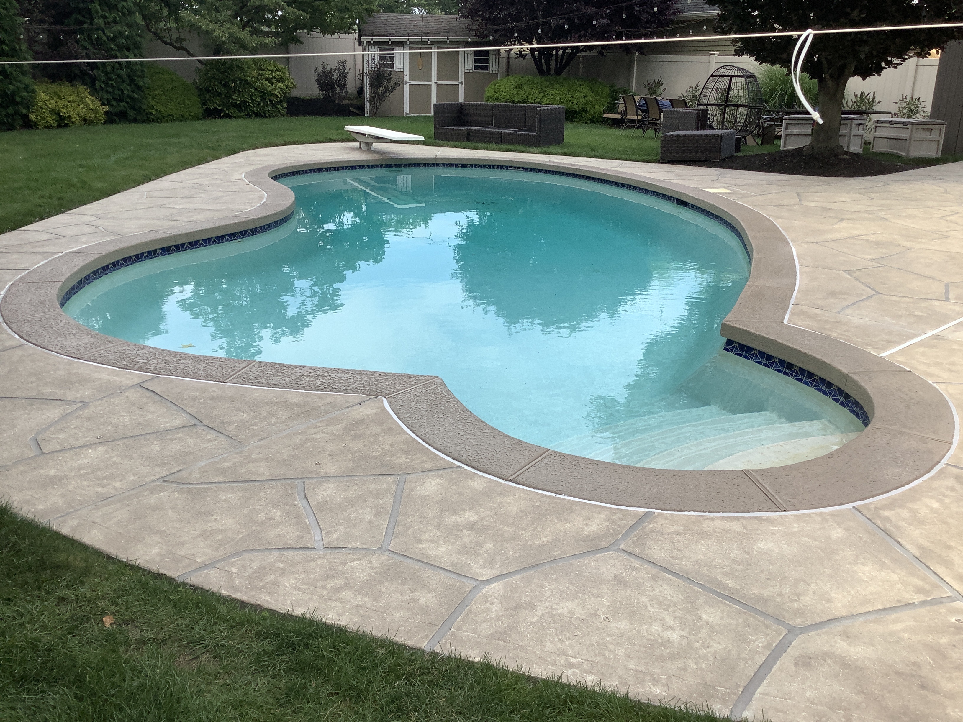 Pool deck resurfaced in Sandstone finish with subtle textured pattern in Princeton, NJ
