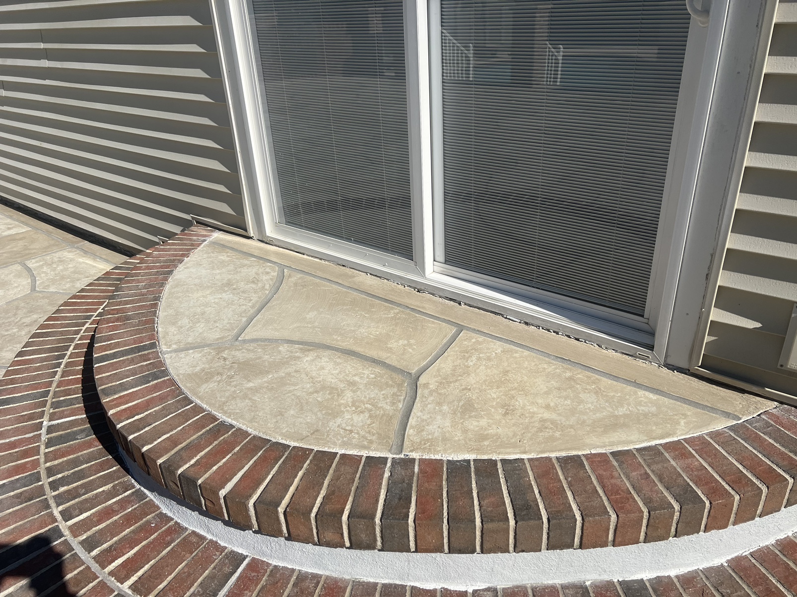 Pool deck resurfaced in Sandstone finish with light, warm stone aesthetic