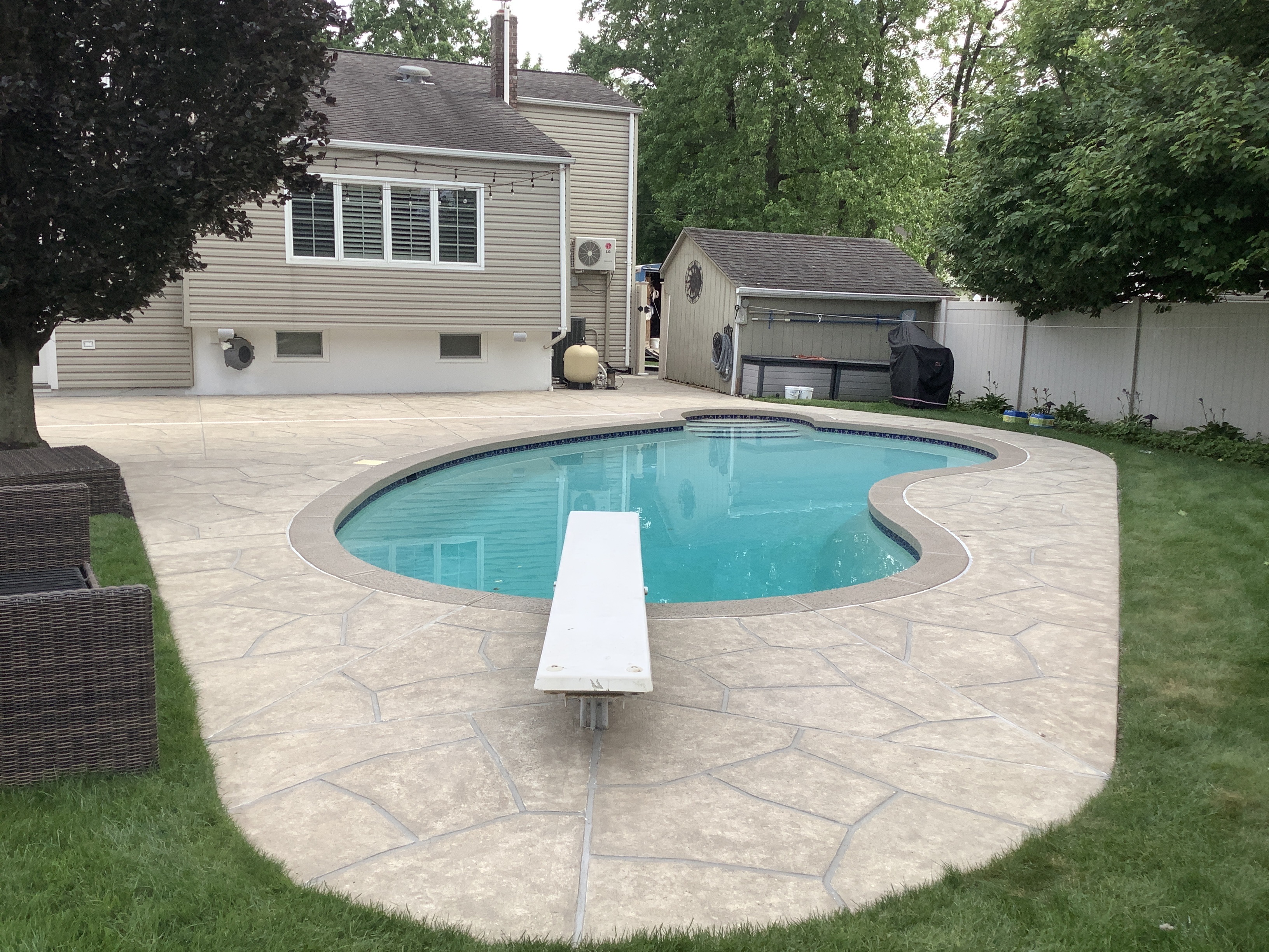 Sandstone concrete pool deck repair featuring light, warm stone aesthetic in Plymouth, MA