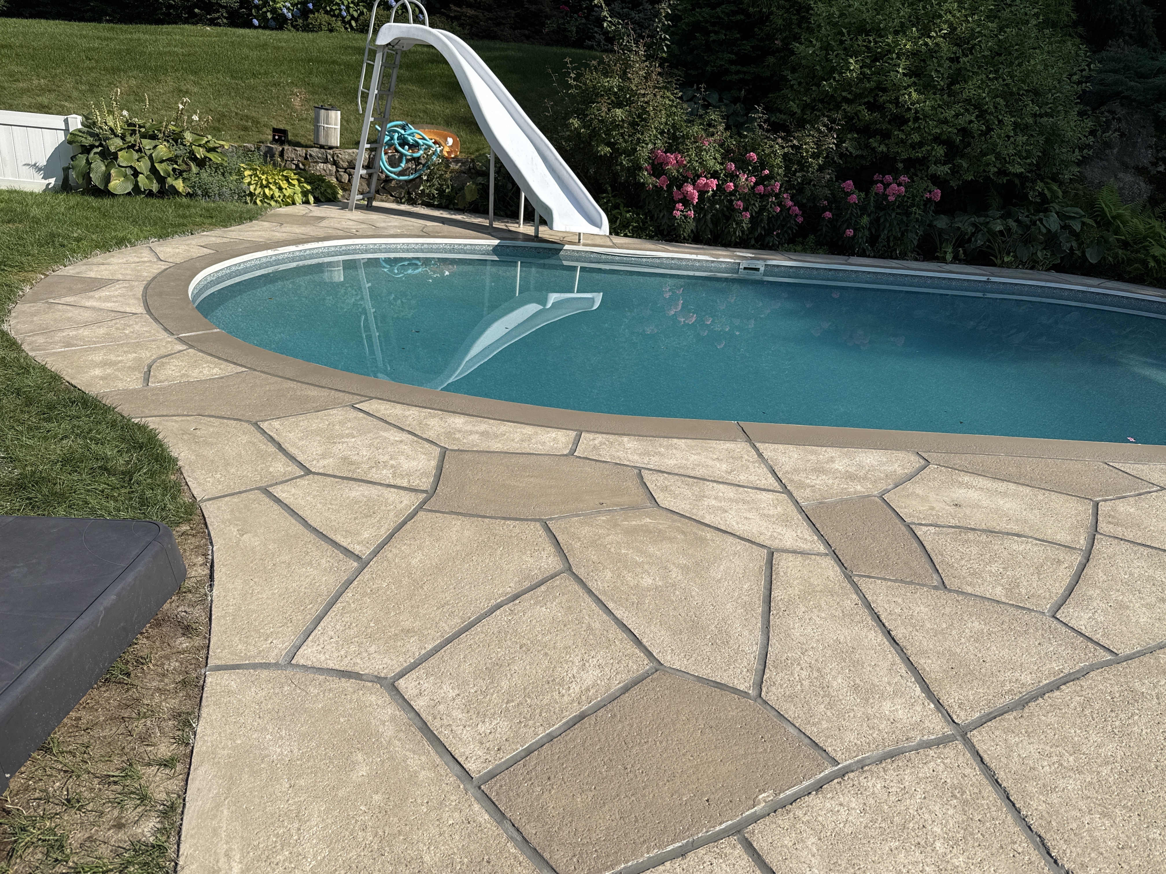 Warm-toned Sandstone pool deck renovation displaying subtle textured pattern in Annapolis, MD