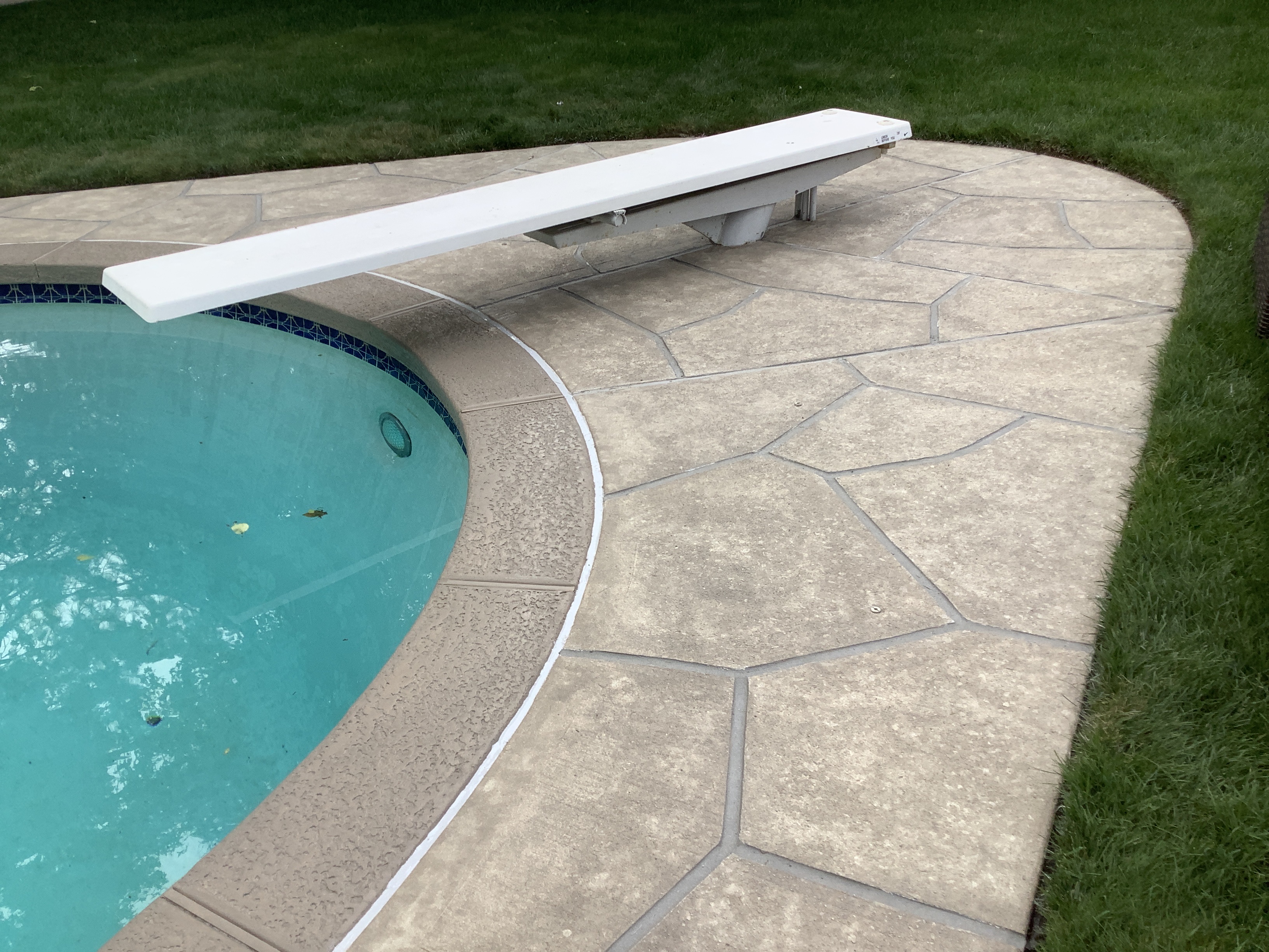 Sandstone concrete pool deck repair featuring subtle textured pattern in Warwick, RI