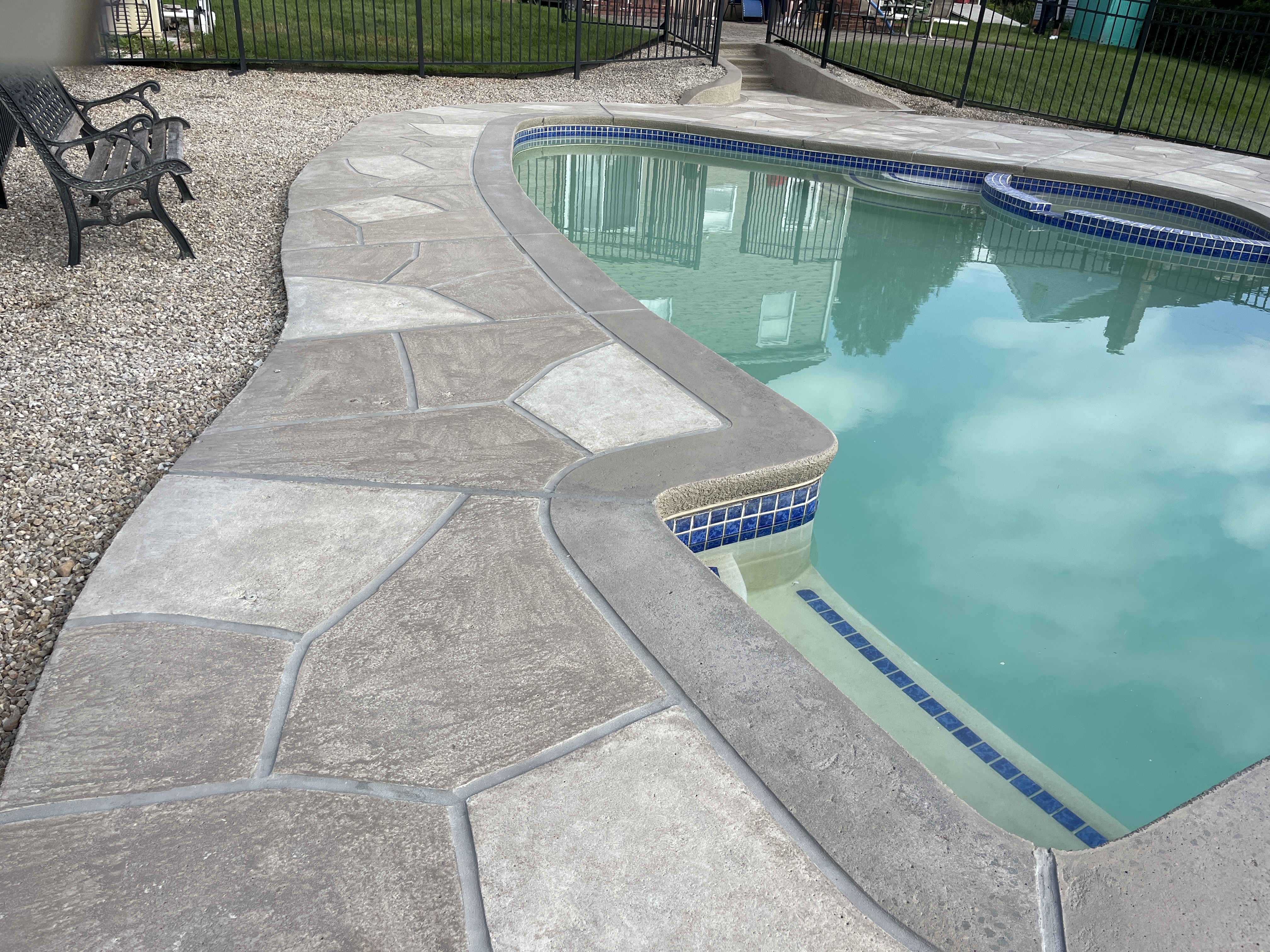RenuKrete resurfaced pool deck in Sandstone showing durable resurfaced concrete