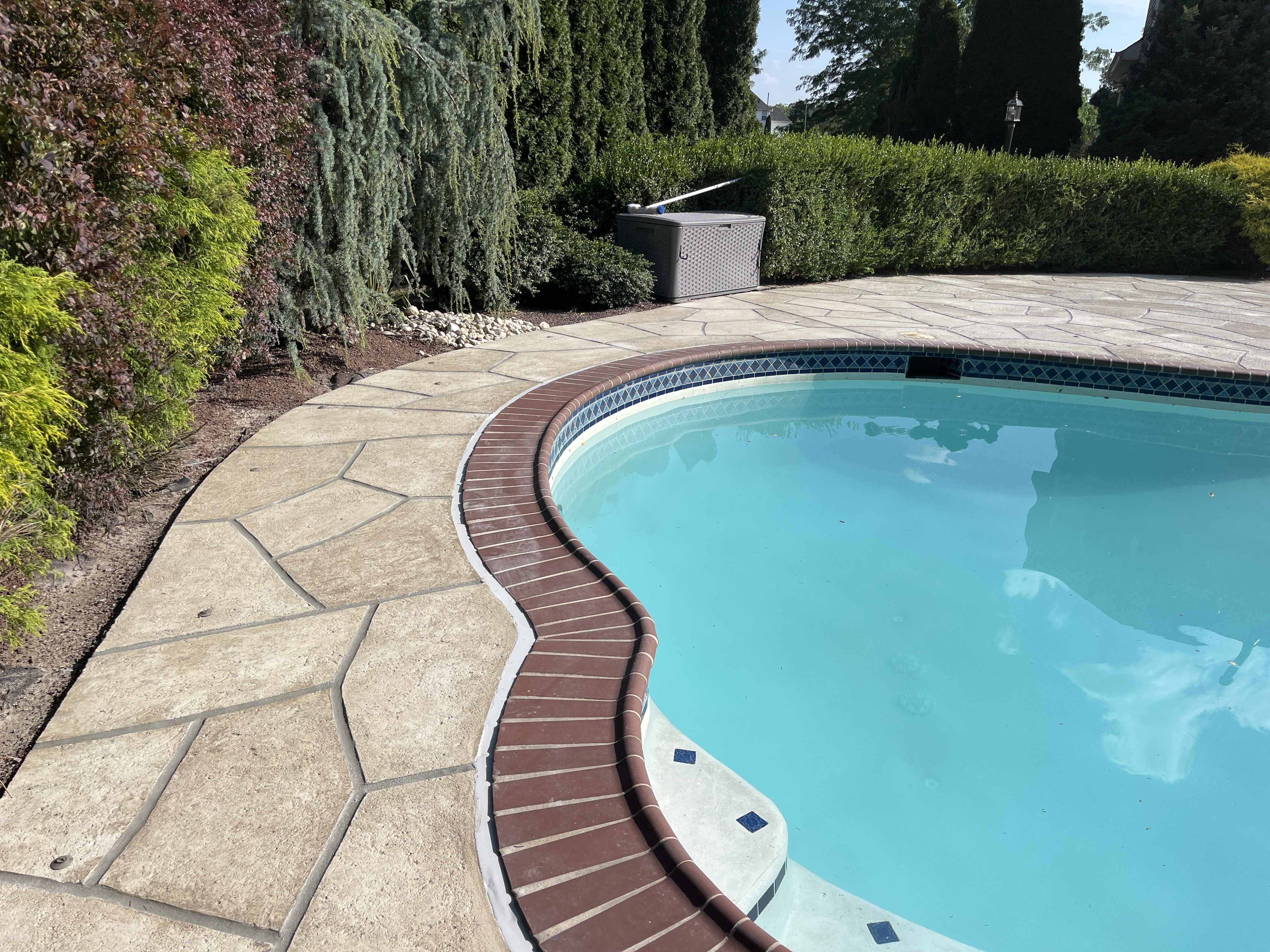 Pool deck resurfaced in Sandstone finish with subtle textured pattern