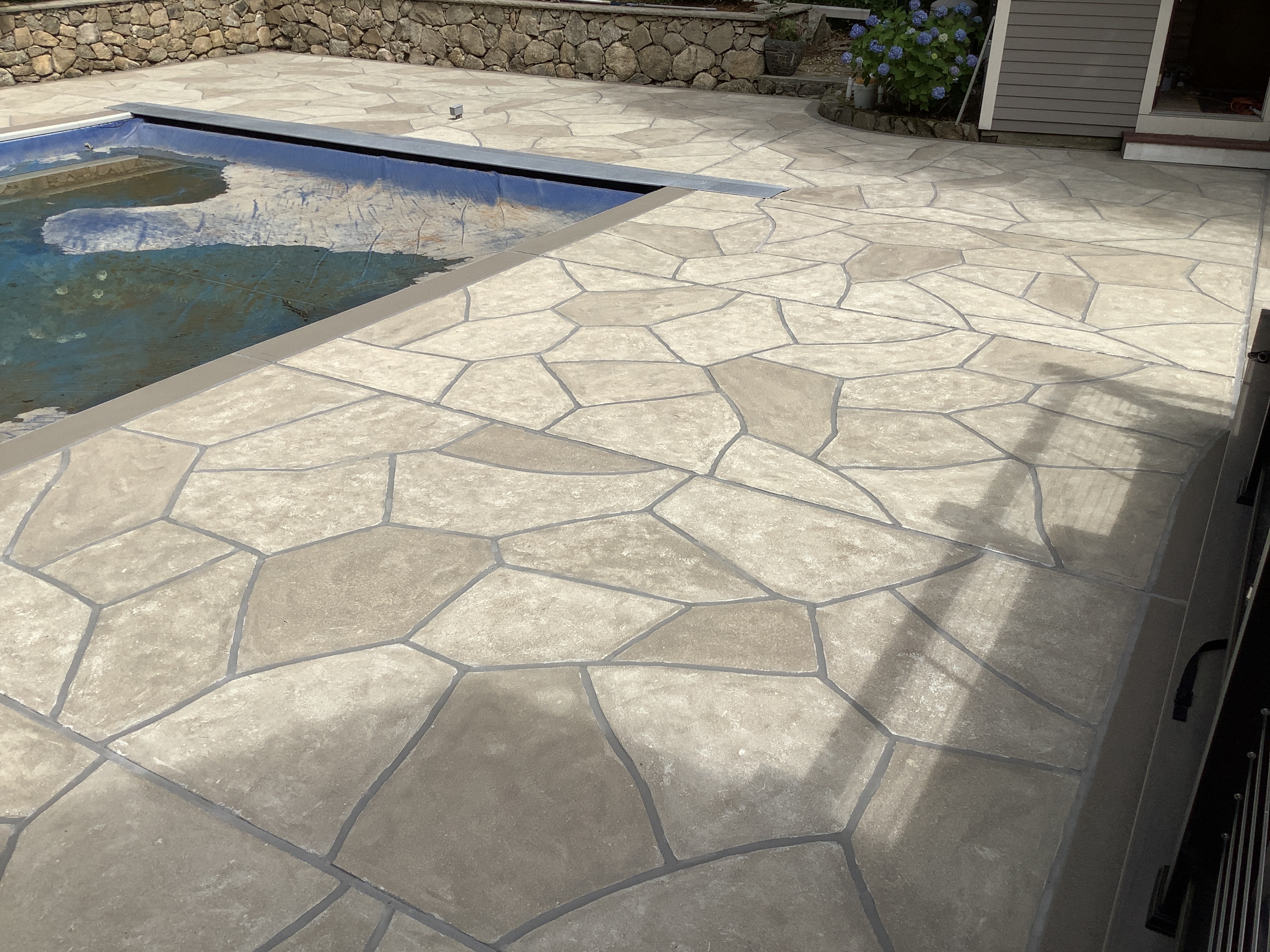 Pool deck resurfaced in Sandstone finish with natural sandstone appearance
