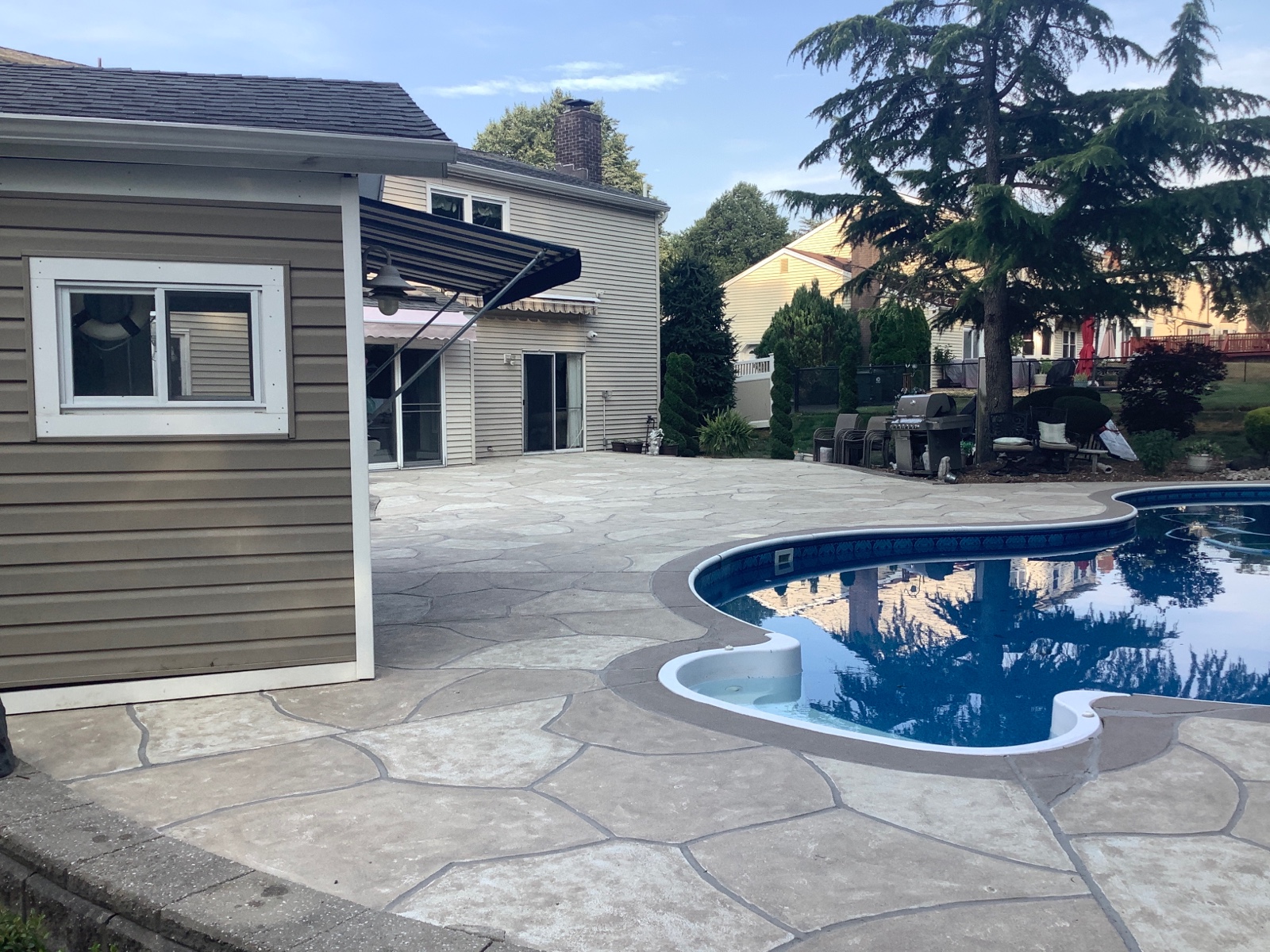 Warm-toned Sandstone pool deck renovation displaying natural sandstone appearance in Marlton, NJ