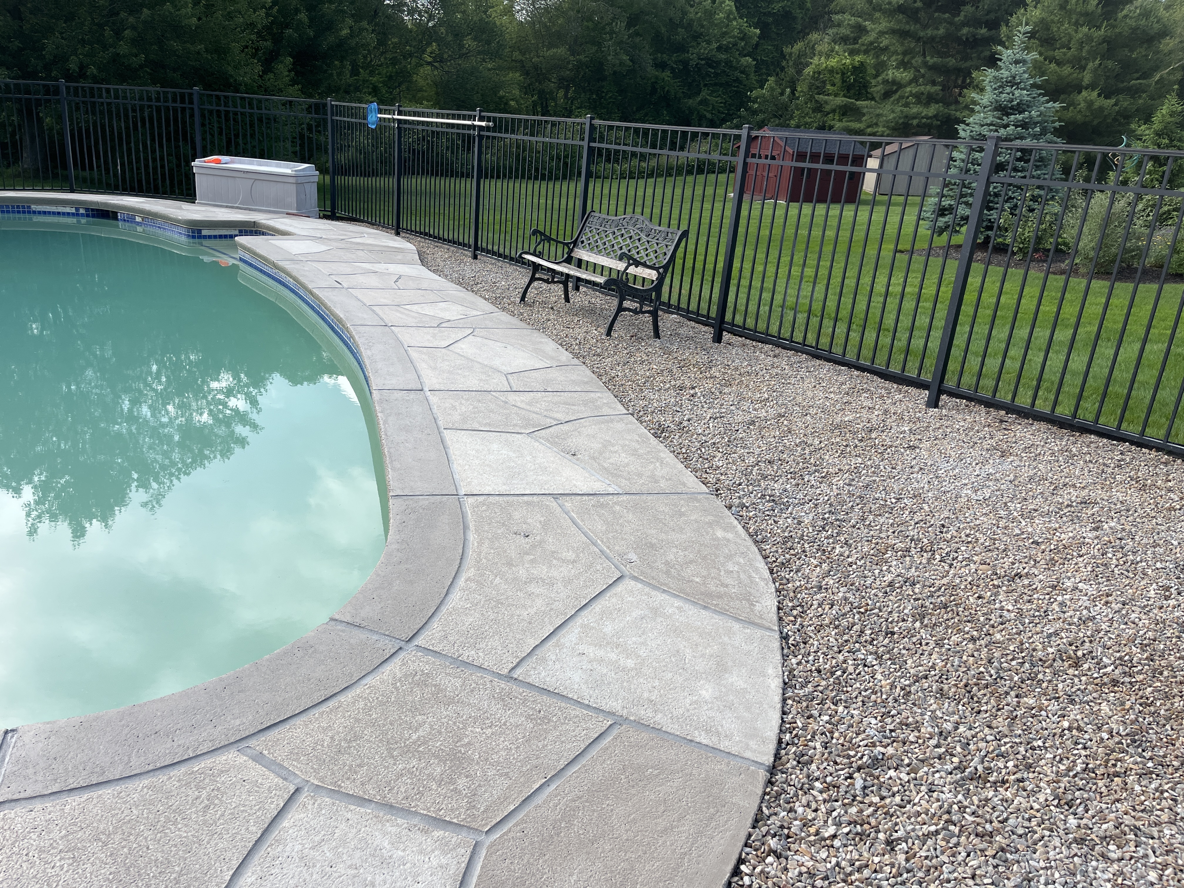 RenuKrete resurfaced pool deck in Sandstone showing warm earth-tone surface in Providence, RI