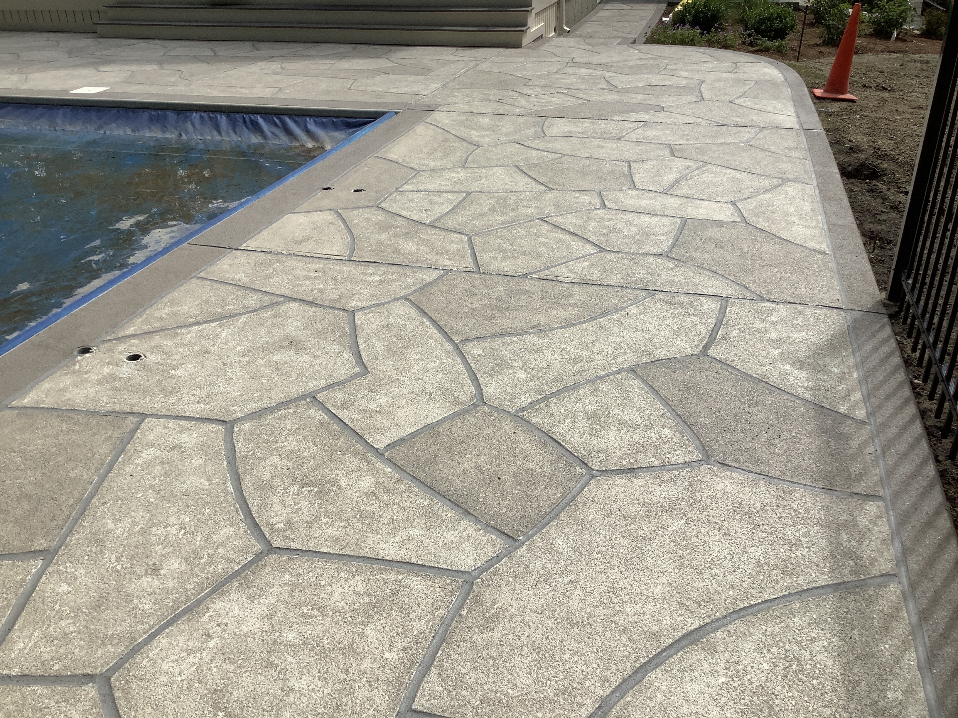 Pool deck resurfaced in Sandstone finish with warm earth-tone surface