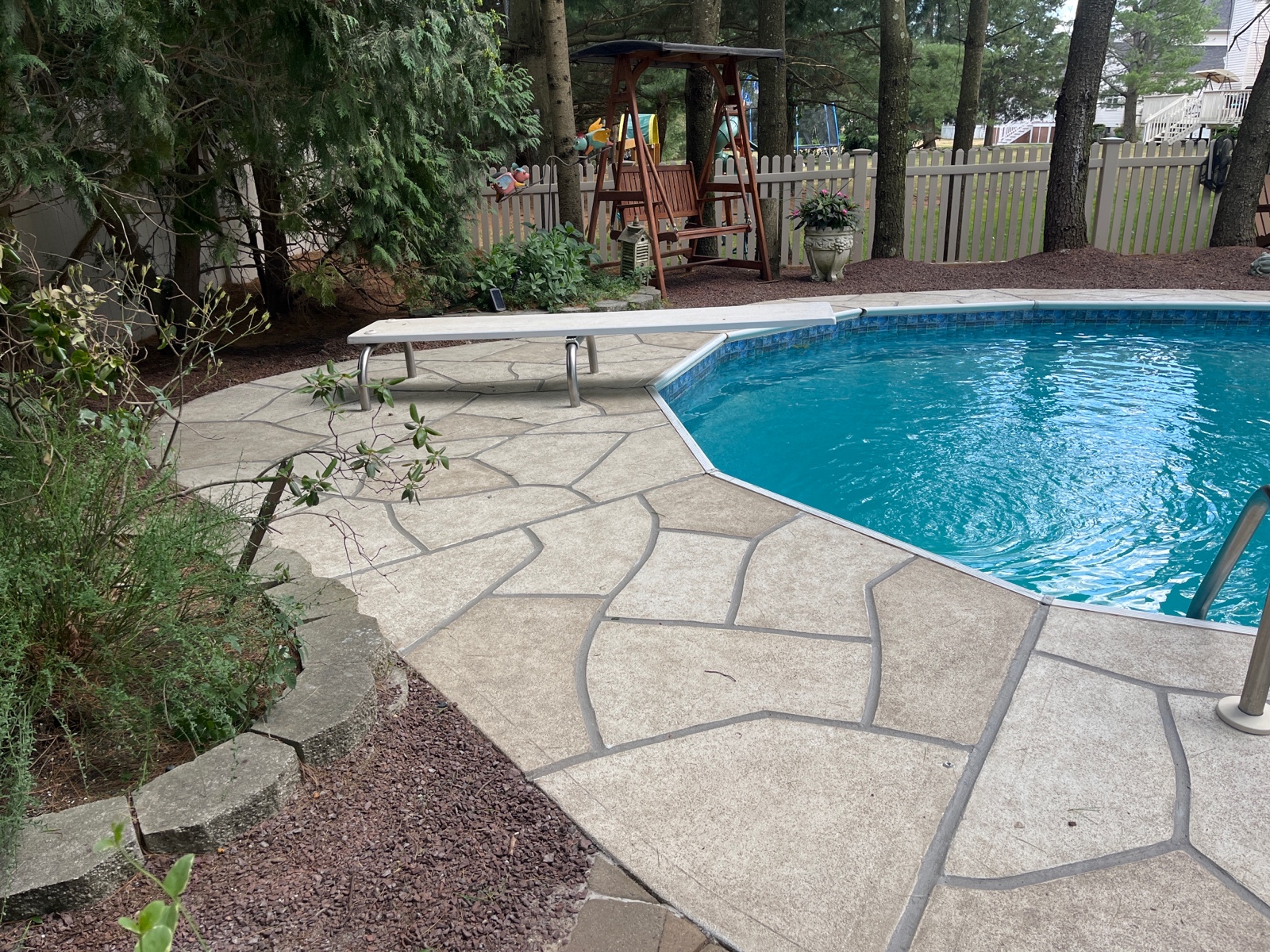Sandstone decorative concrete pool deck resurfacing project with warm natural stone appearance