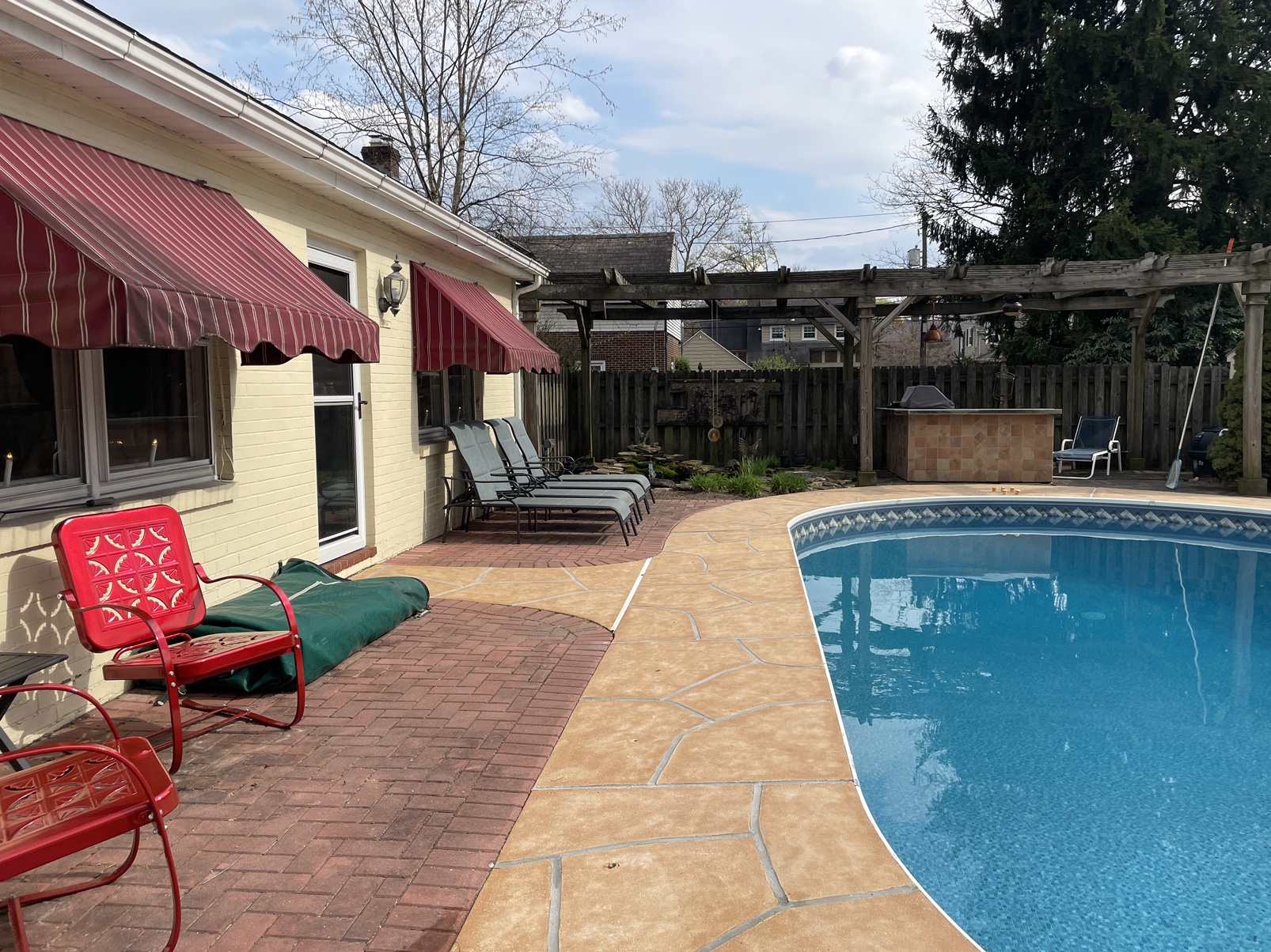 Warm-toned Tuscany pool deck renovation with subtle textured surface in Stamford, CT