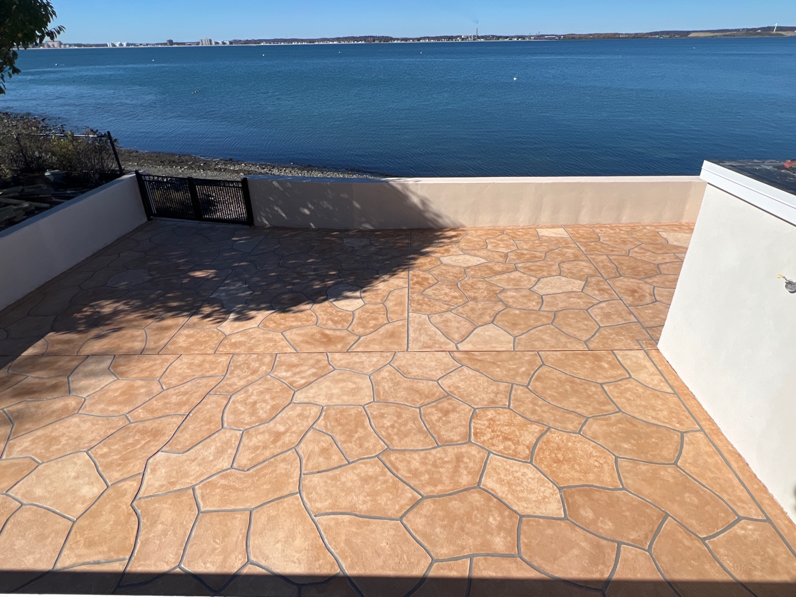 Warm-toned Tuscany patio renovation with durable resurfaced concrete